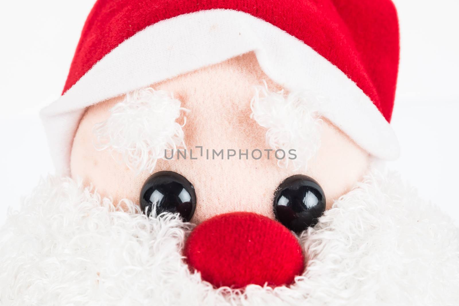 close up image of Santa Claus doll with green sack on white background
