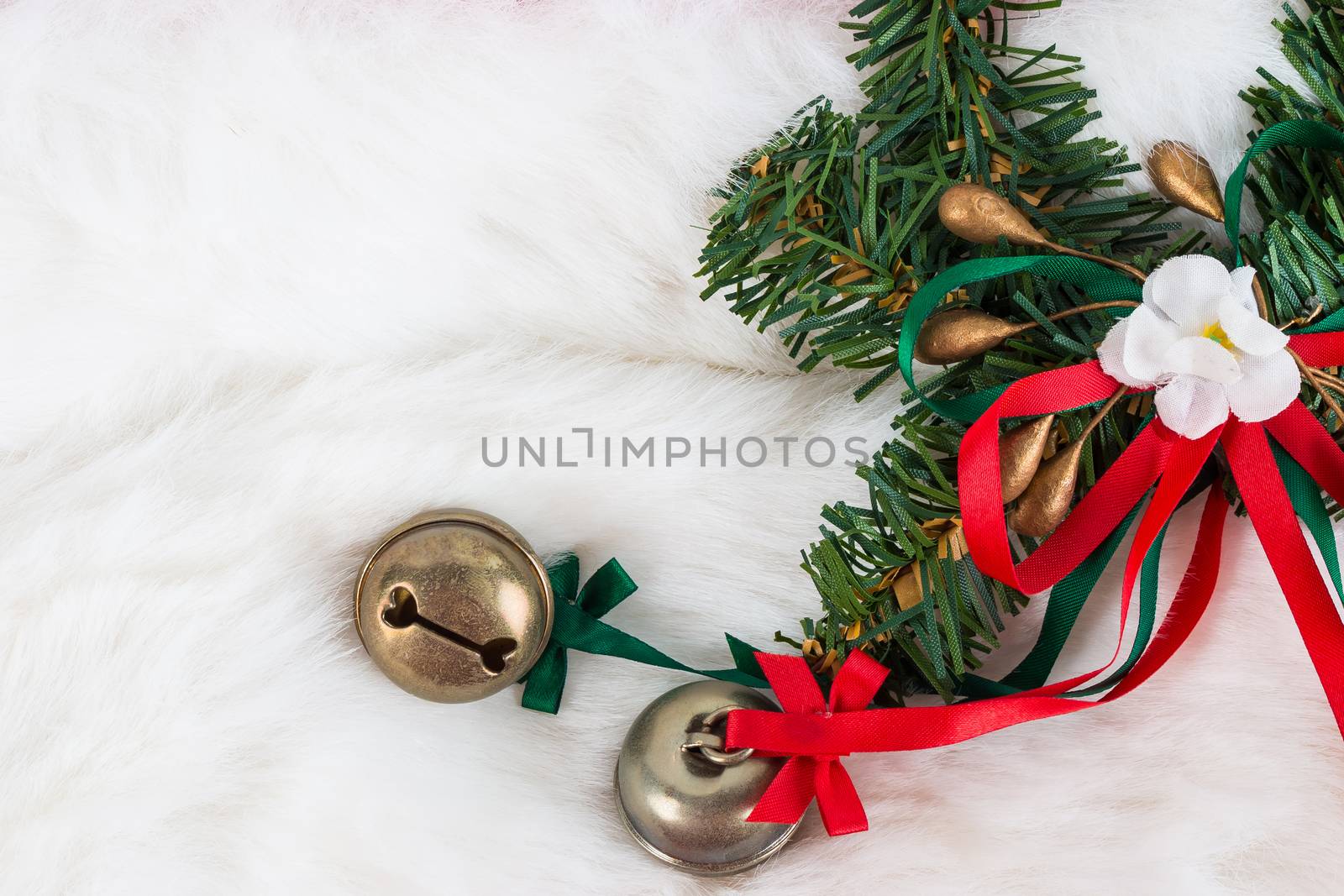 Christmas garland and small bells on white fur