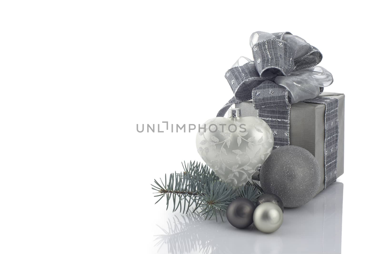 Christmas decoration with ball ornaments and gift box over white background