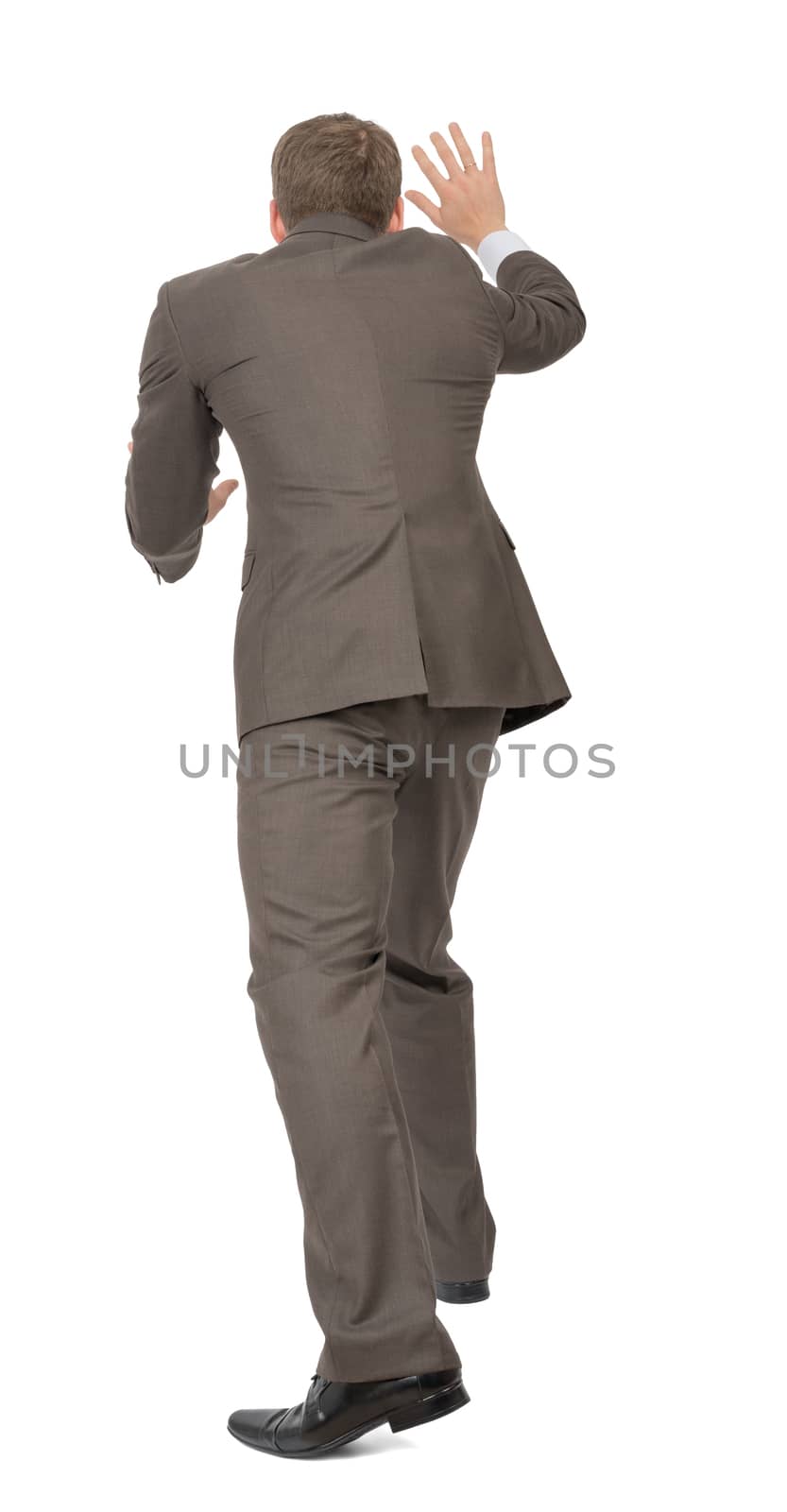 Businessman pushing empty space on isolated white background, rear view