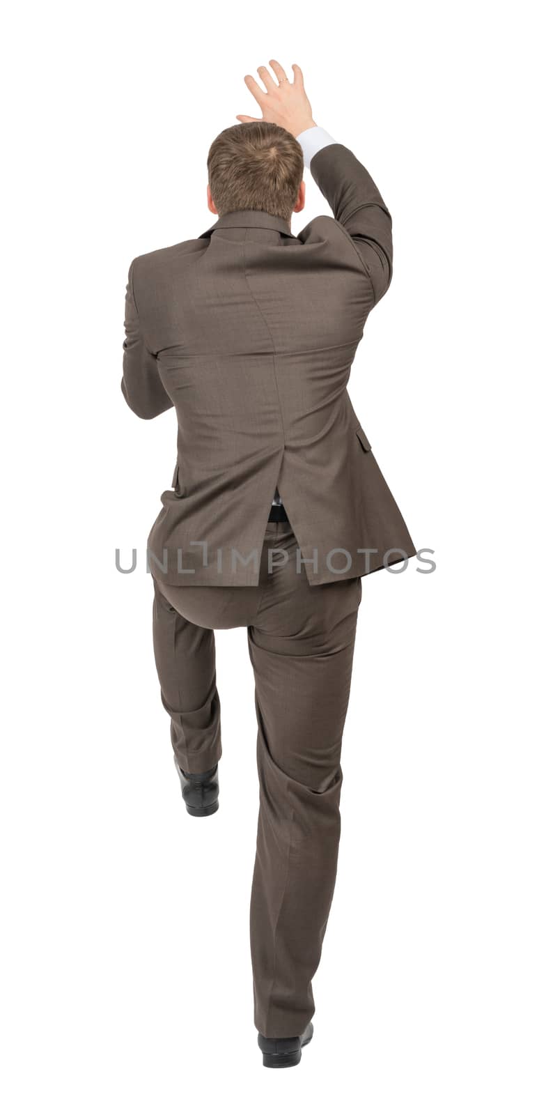 Businessman climbing empty space, rear view by cherezoff