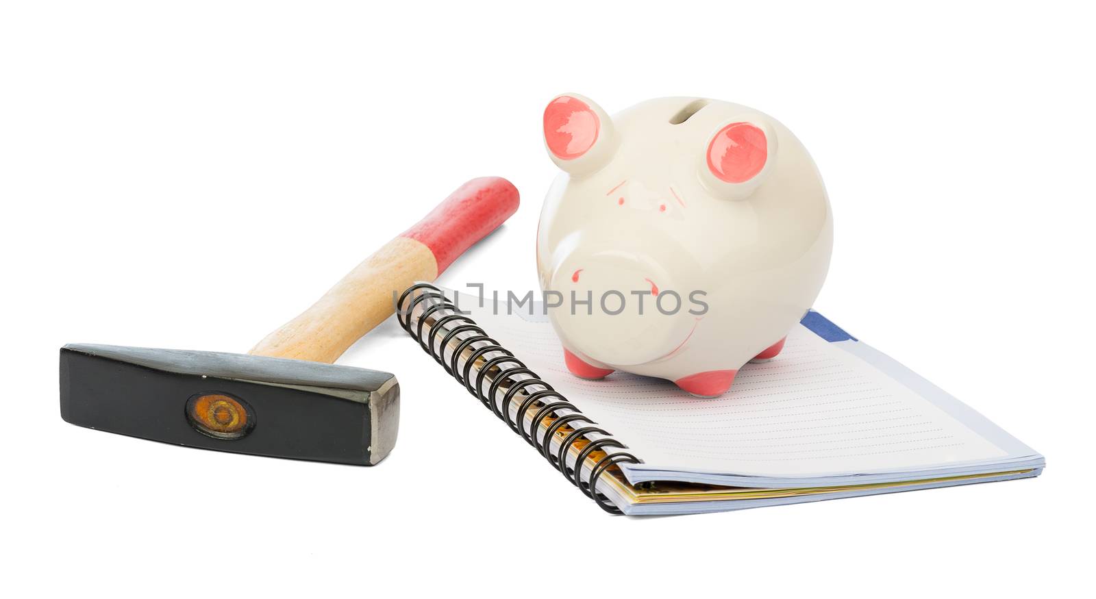 Piggy bank with hammer and pad on isolated white background