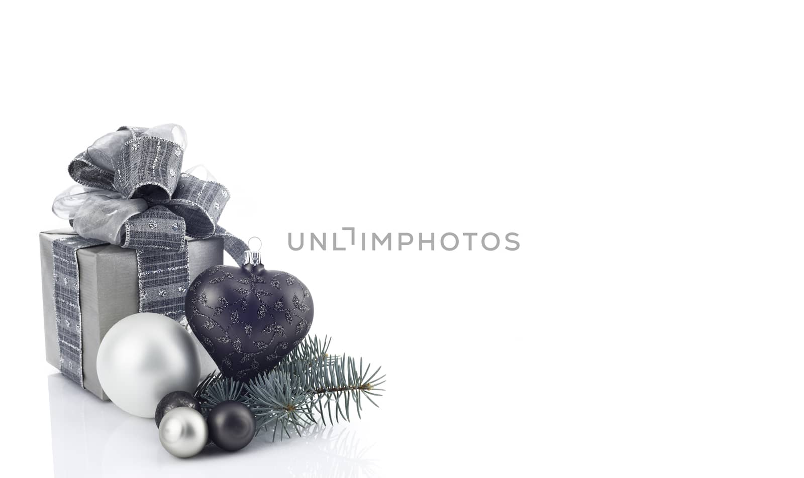 Christmas decoration with ball ornaments and gift box over white background