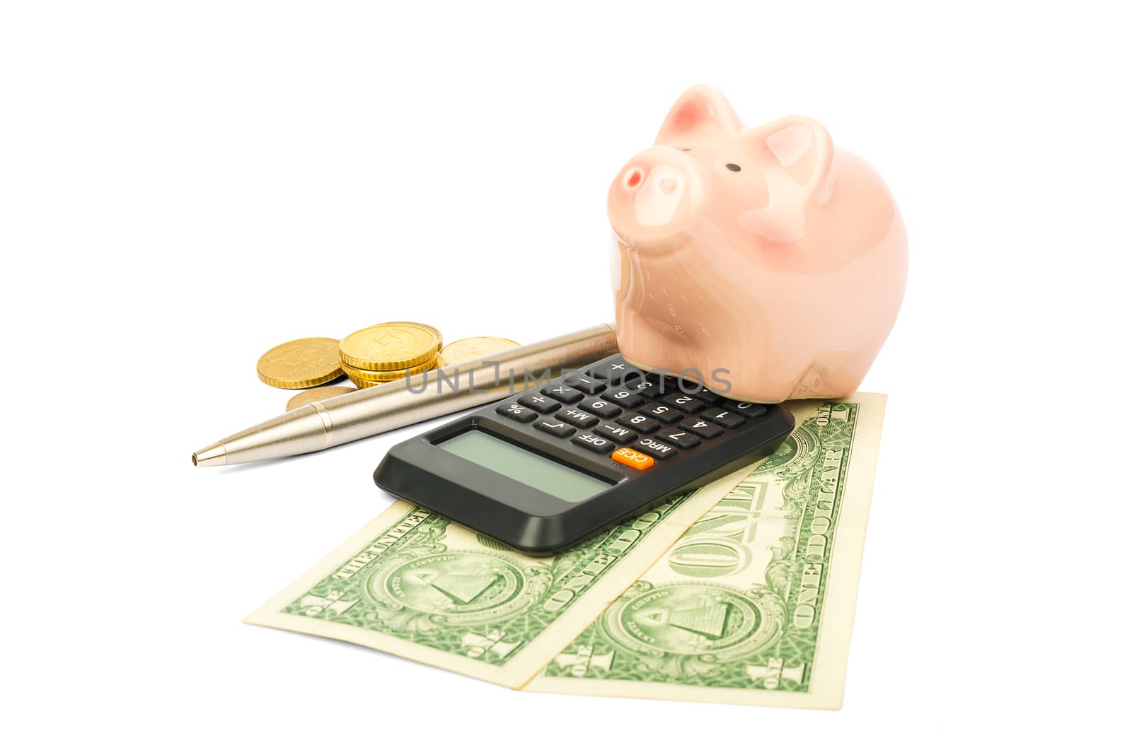 Piggy bank with coins and pen on isolated white background