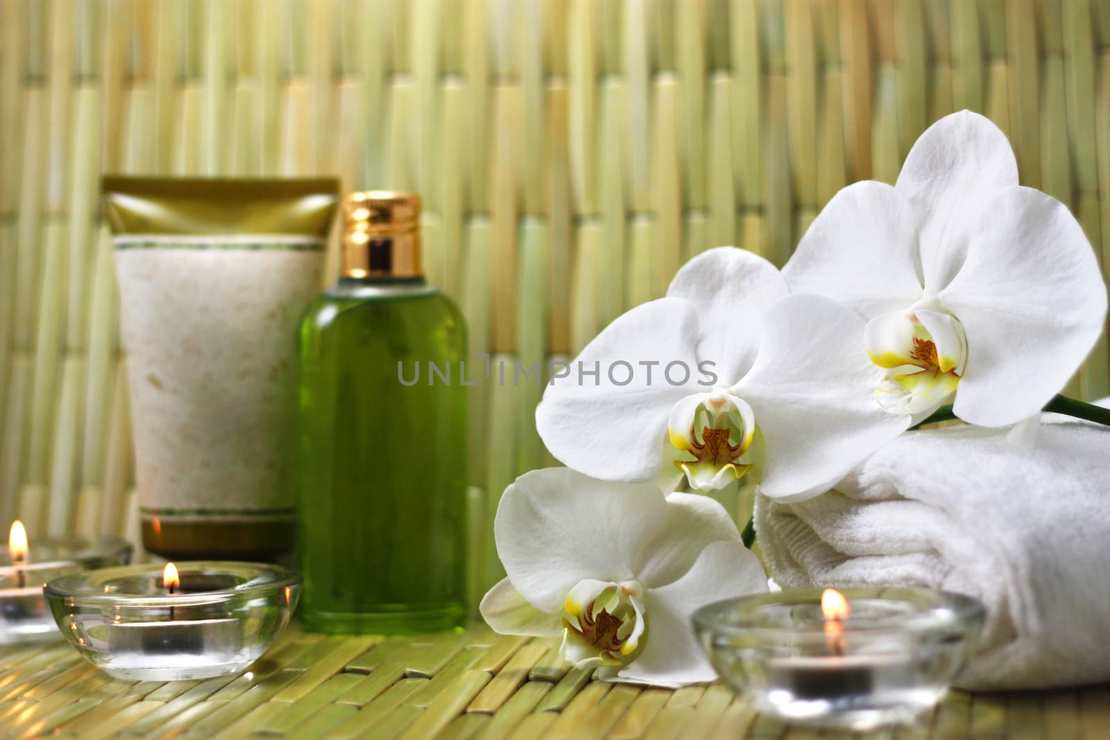 Orchid, candles and body care products in the spa