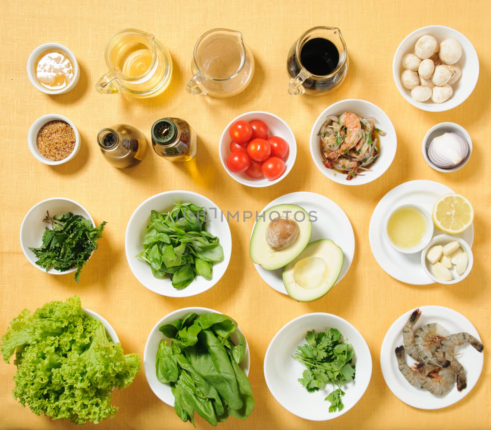 Ingredients for salad in seaparate plates on yellow background