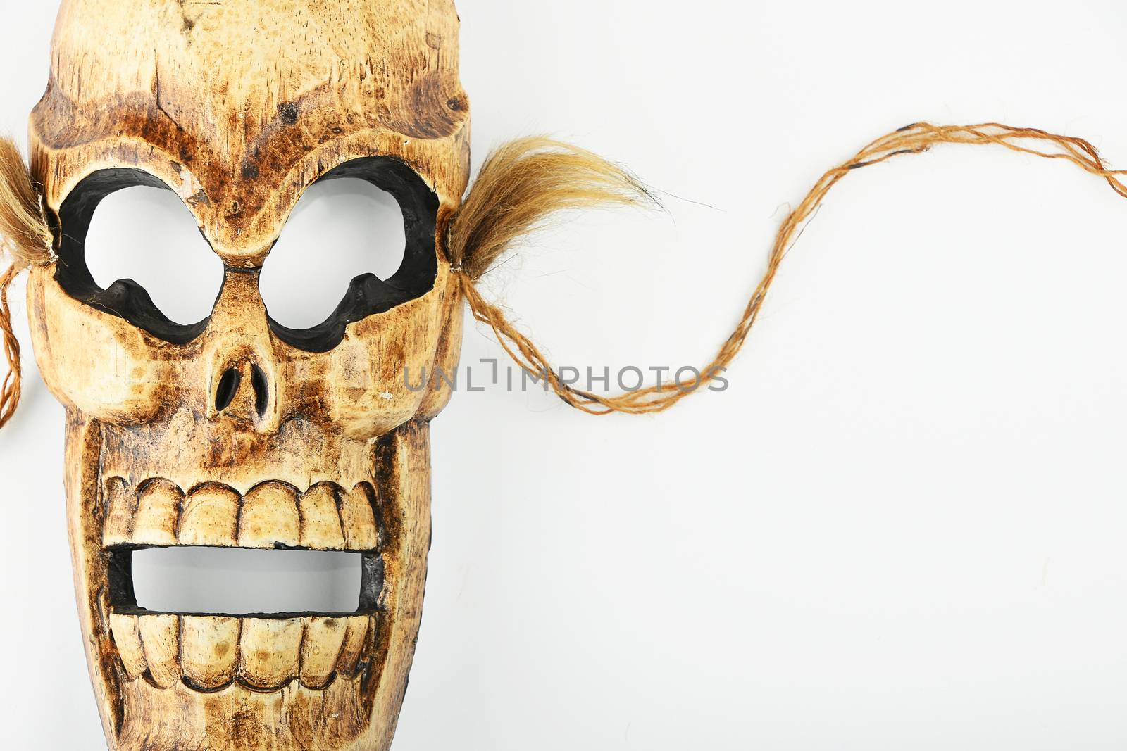 Wooden carved skull death mask on white by BreakingTheWalls