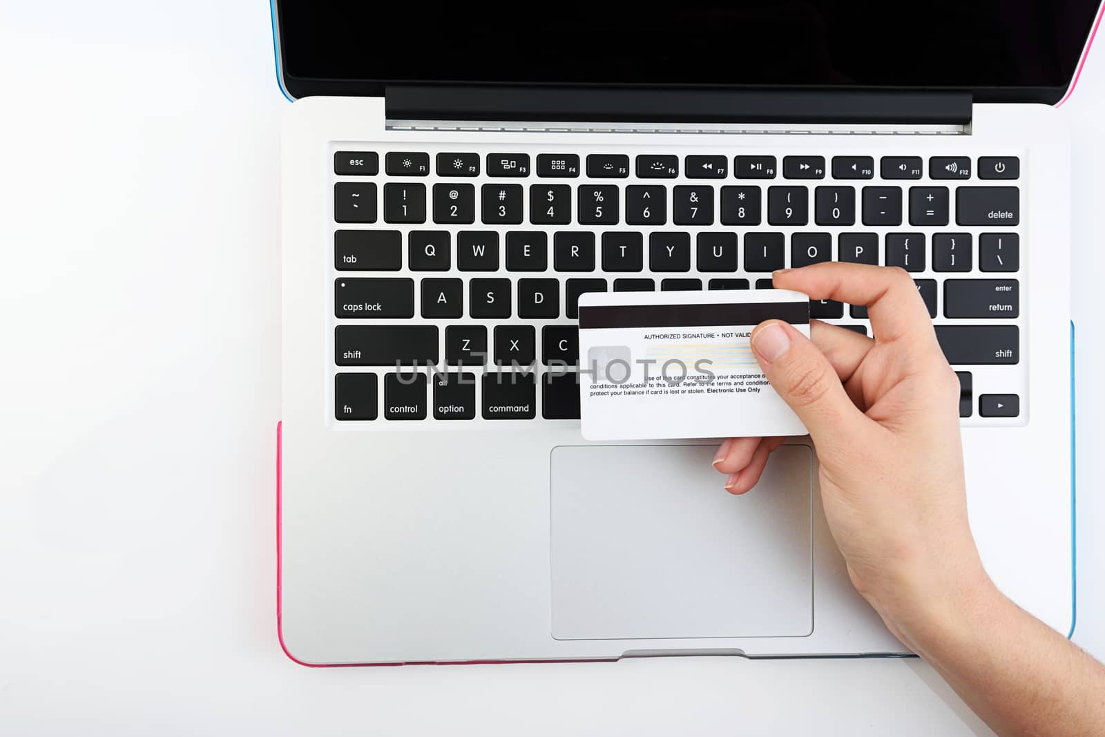 view from top of Human next to laptop with credit card on white background