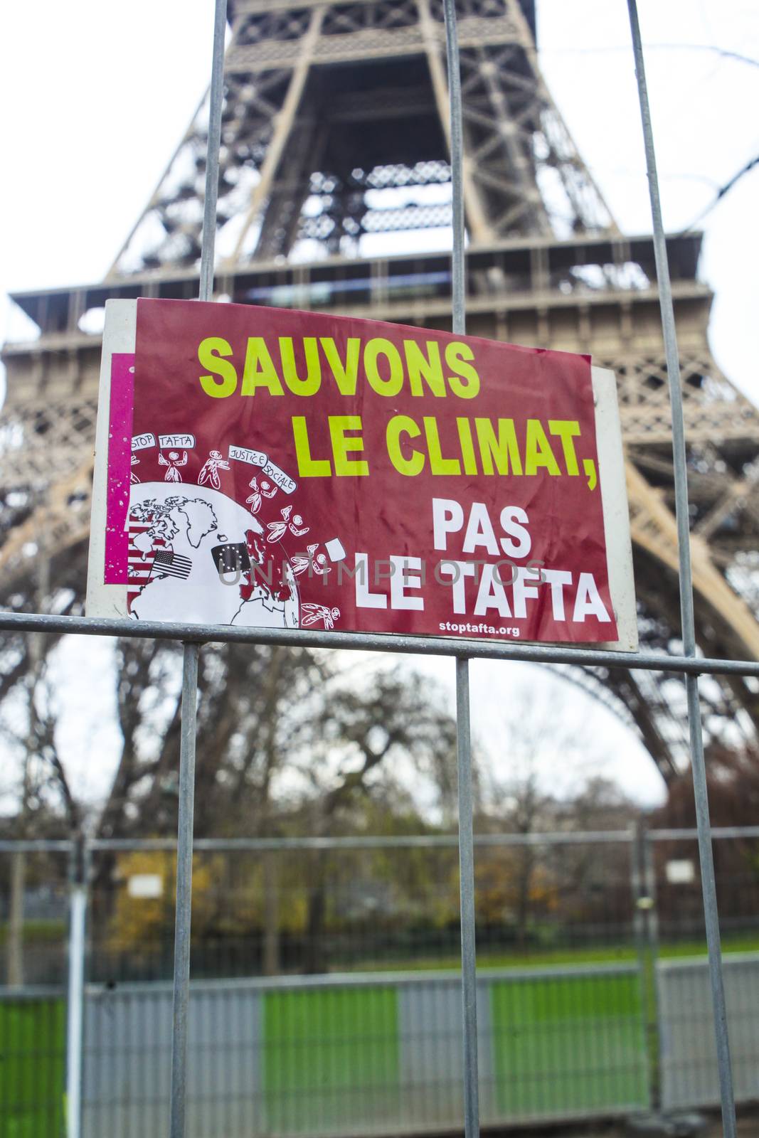 FRANCE, Paris : A sign reading Save the climate, not the TAFTA is seen on the Champ-de-Mars, near Paris Eiffel tower on December 12, 2015 as thousands of people demonstrate for environment protection. 