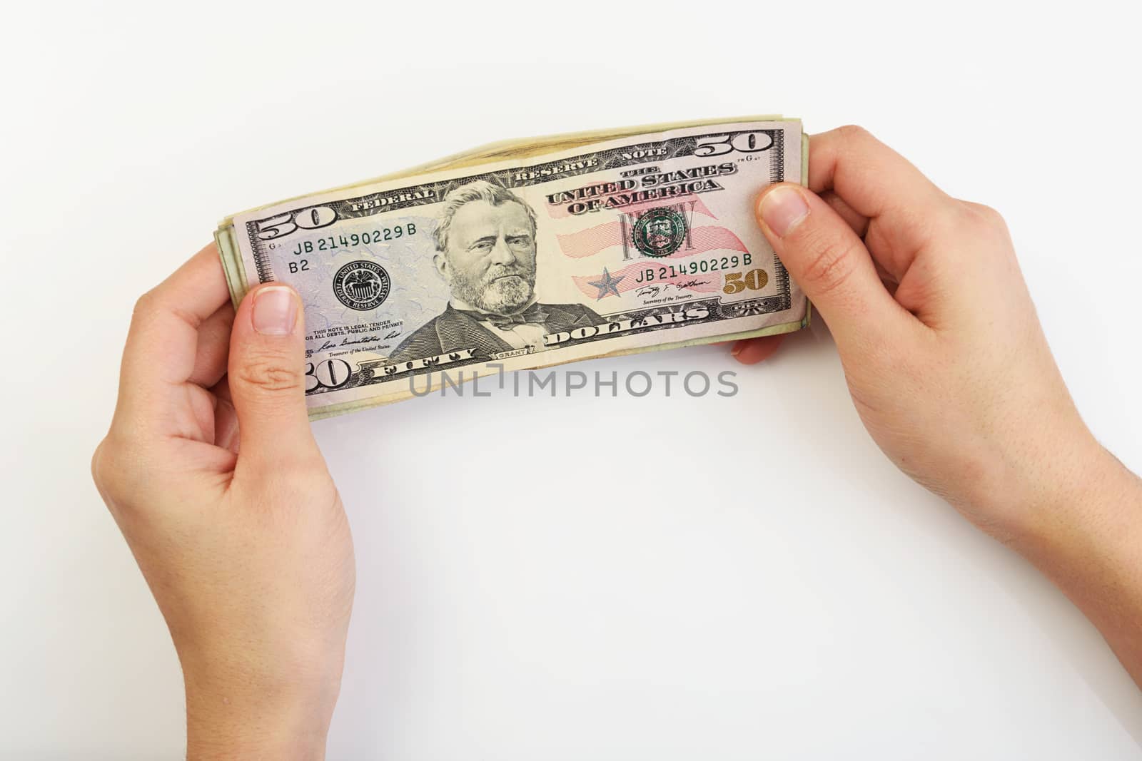 Person holding dollars in hands on white background