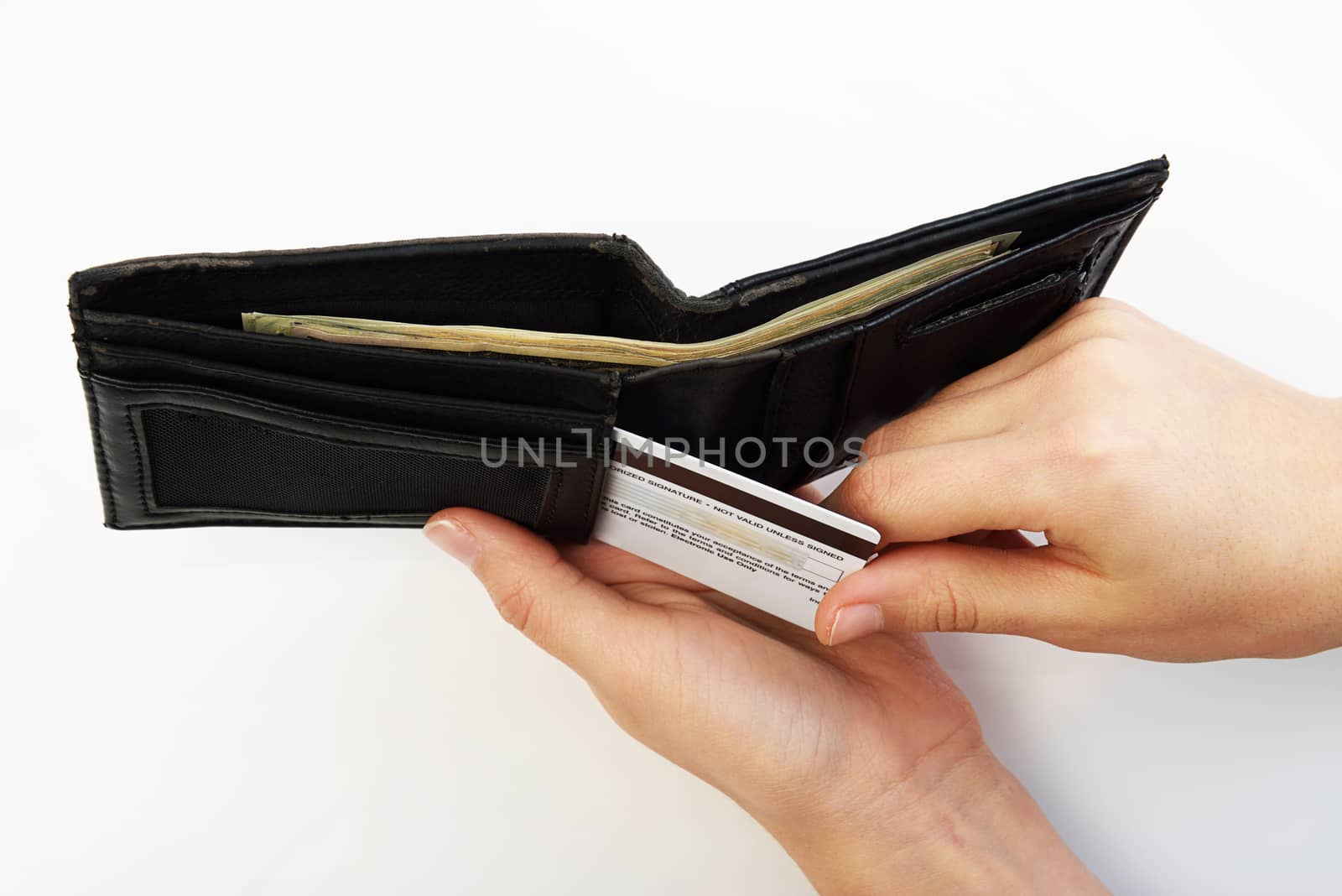 Person taking credit card from black wallet