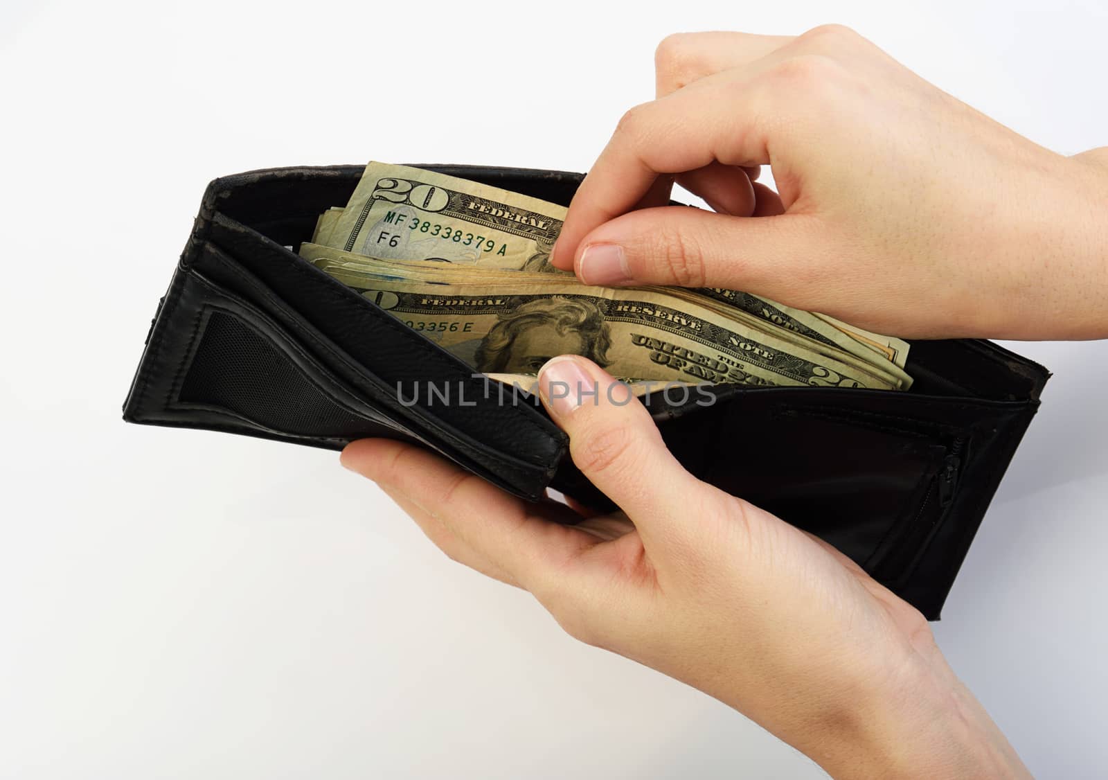 Person taking twenty dollars money from black wallet