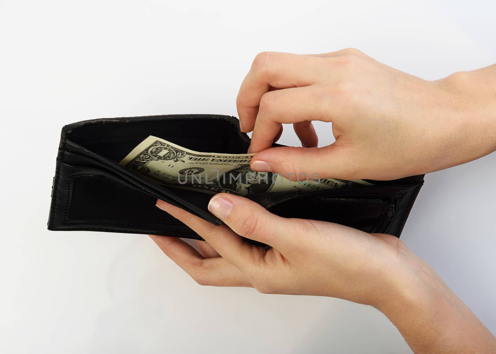 Person taking one dollars bill money from black wallet