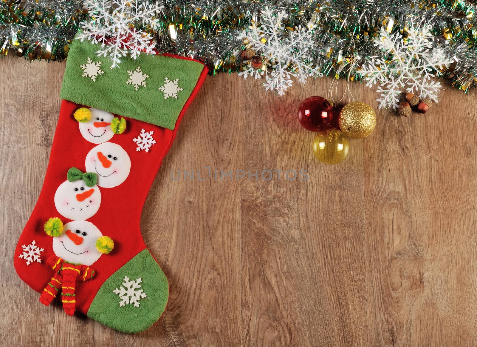 christmas balls and boot on wood floor