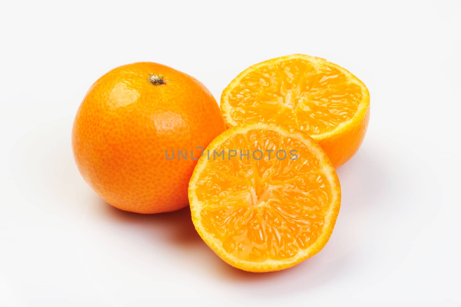 Mandarines in whit background cuted on half