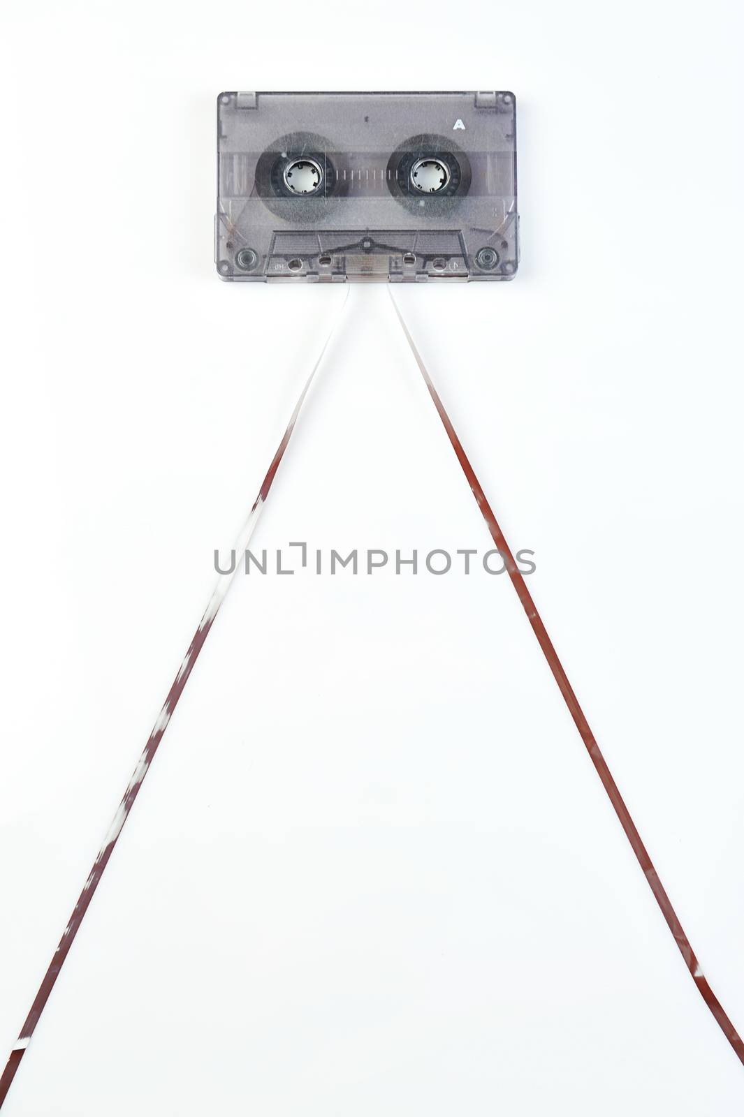 Audio casette with tape on a white background