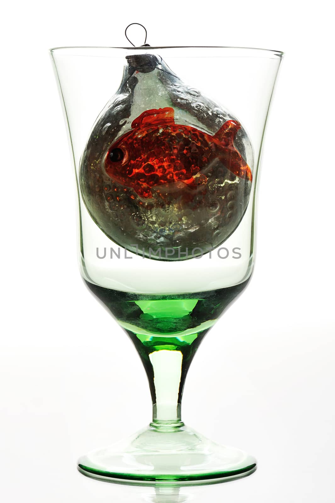 glass with christnmas toy on a white background