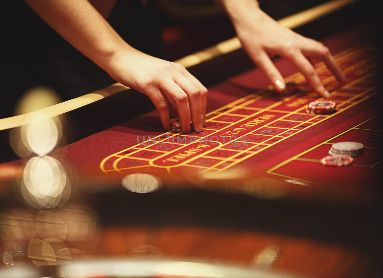 Chips as stock on red table in casino