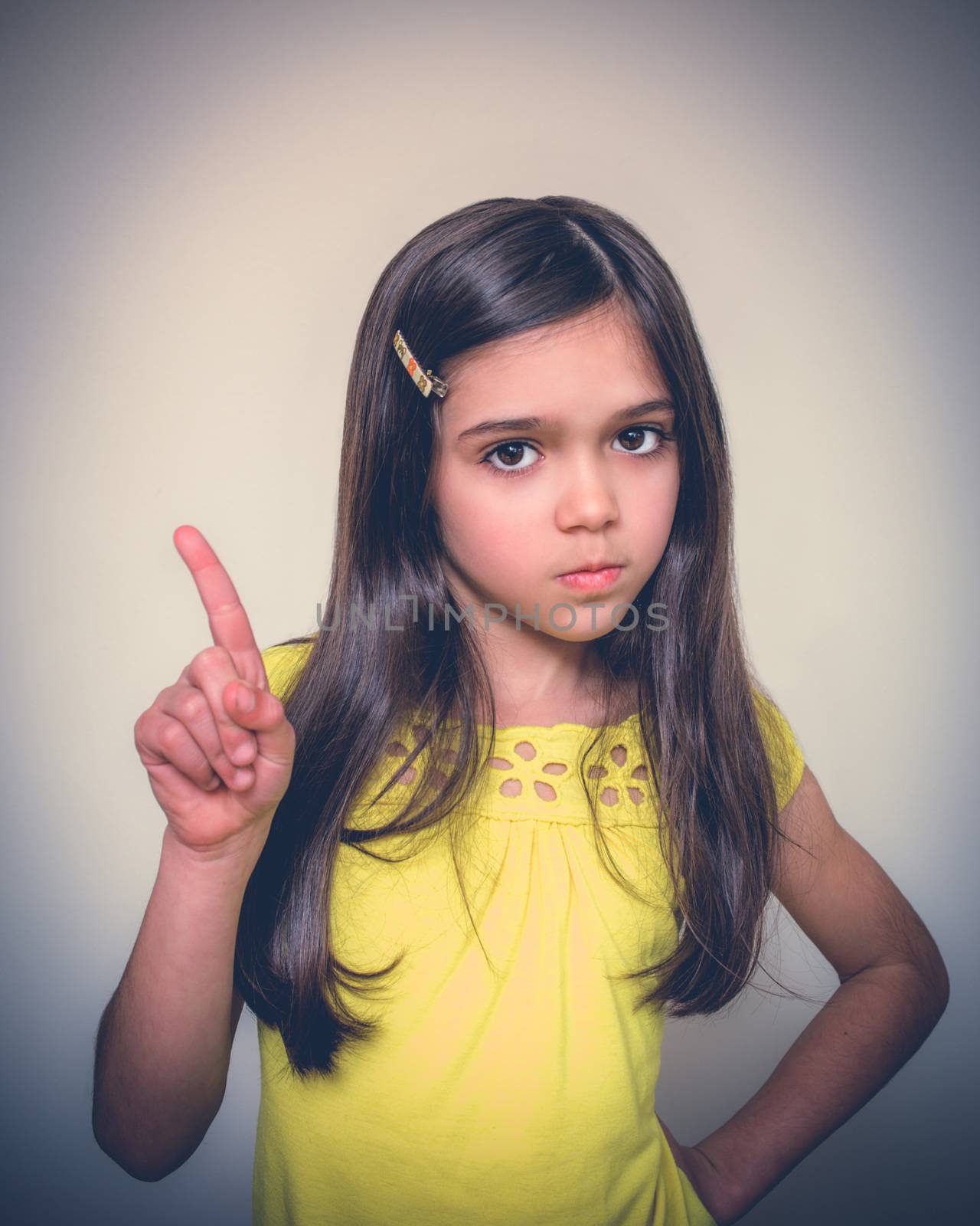 Young girl with borwn hair acts in studio.