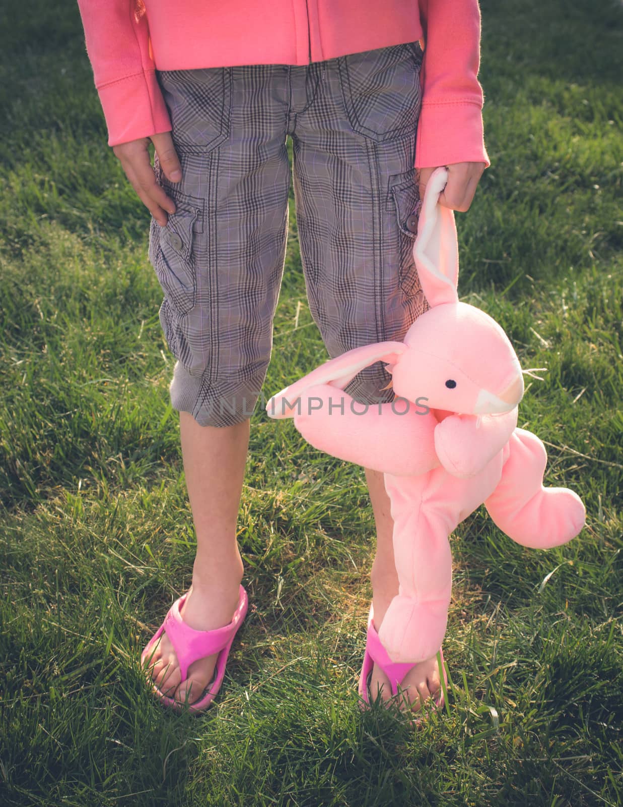 Young girl with brown hair is playing outside.