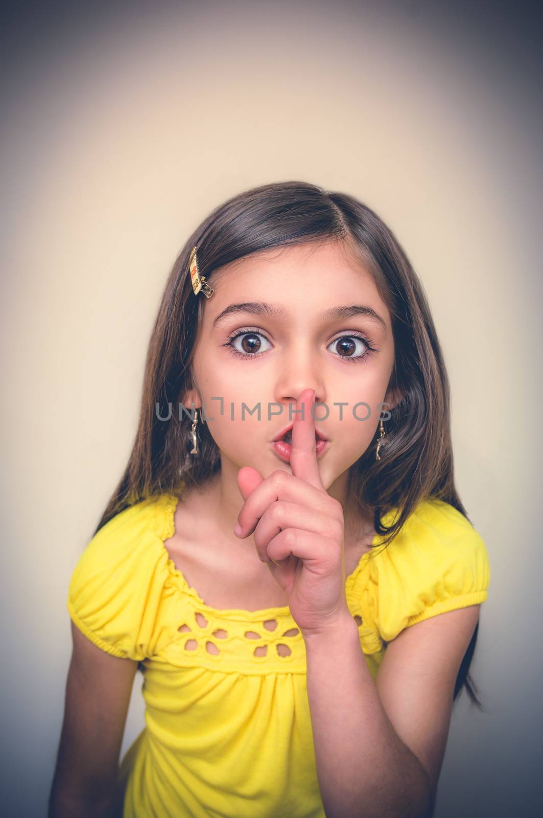 Young girl with borwn hair acts in studio.