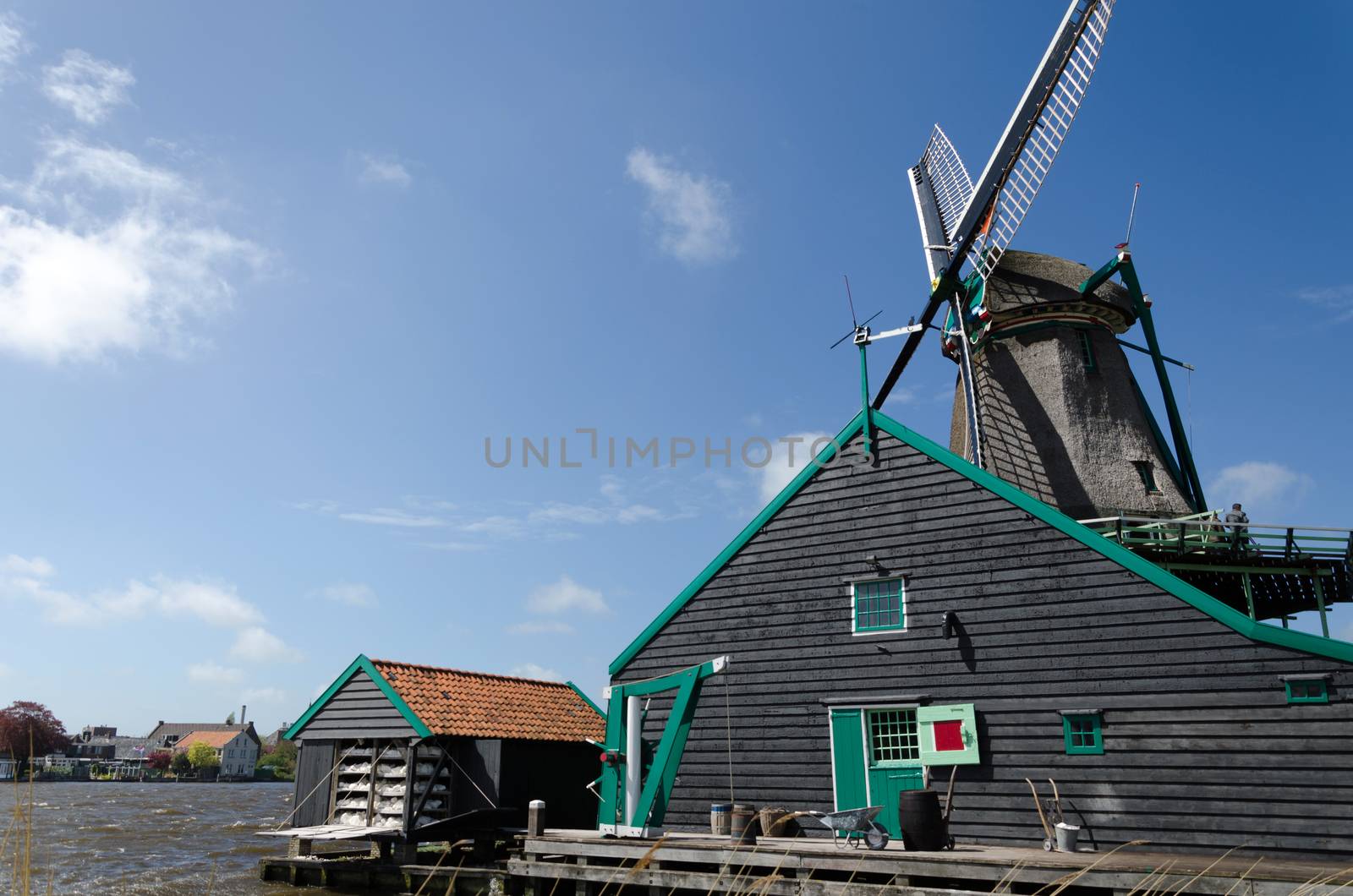 Wind mill with rural house of Zaanse Schans by siraanamwong