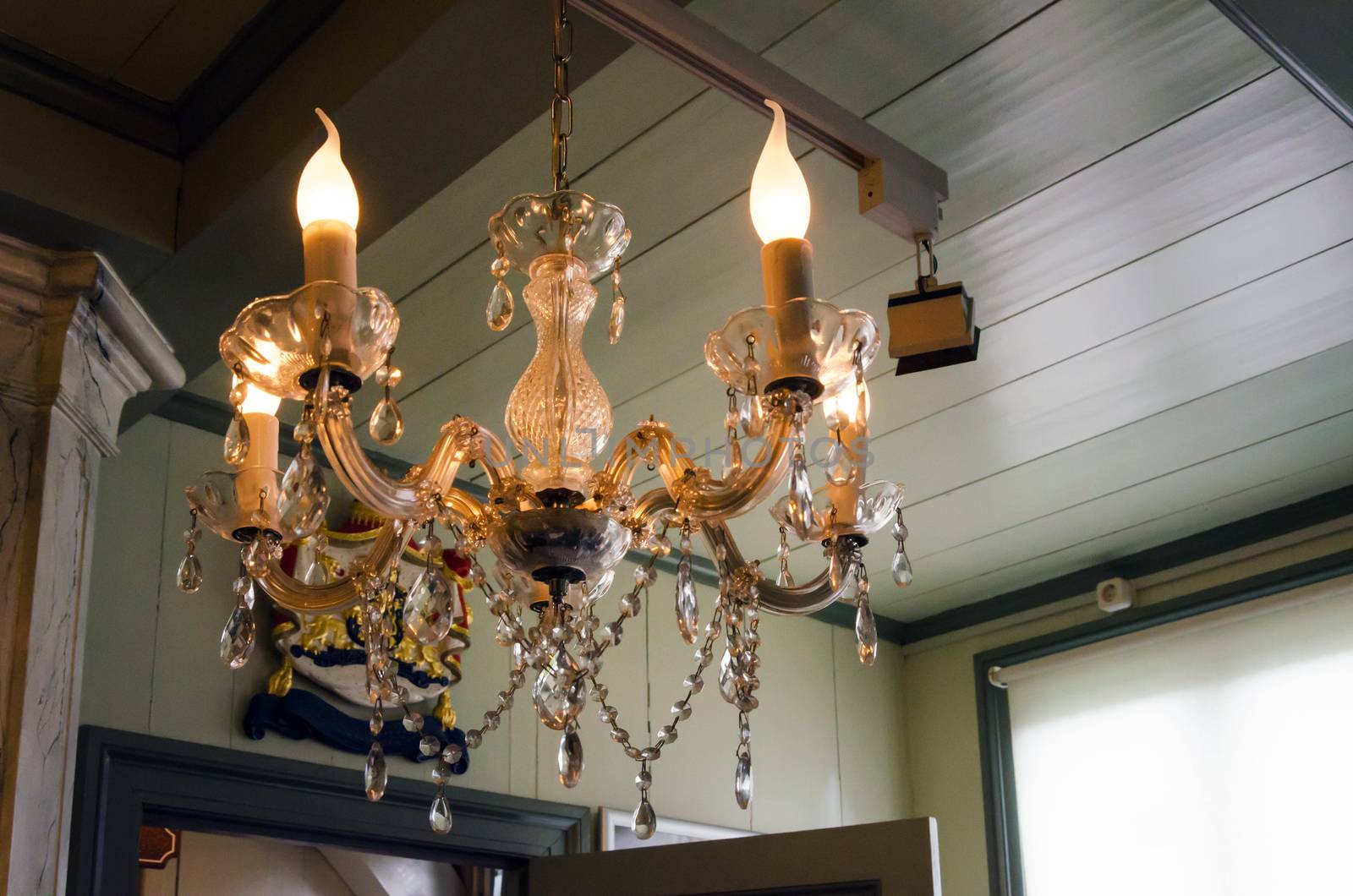 Classic chandelier in room shining