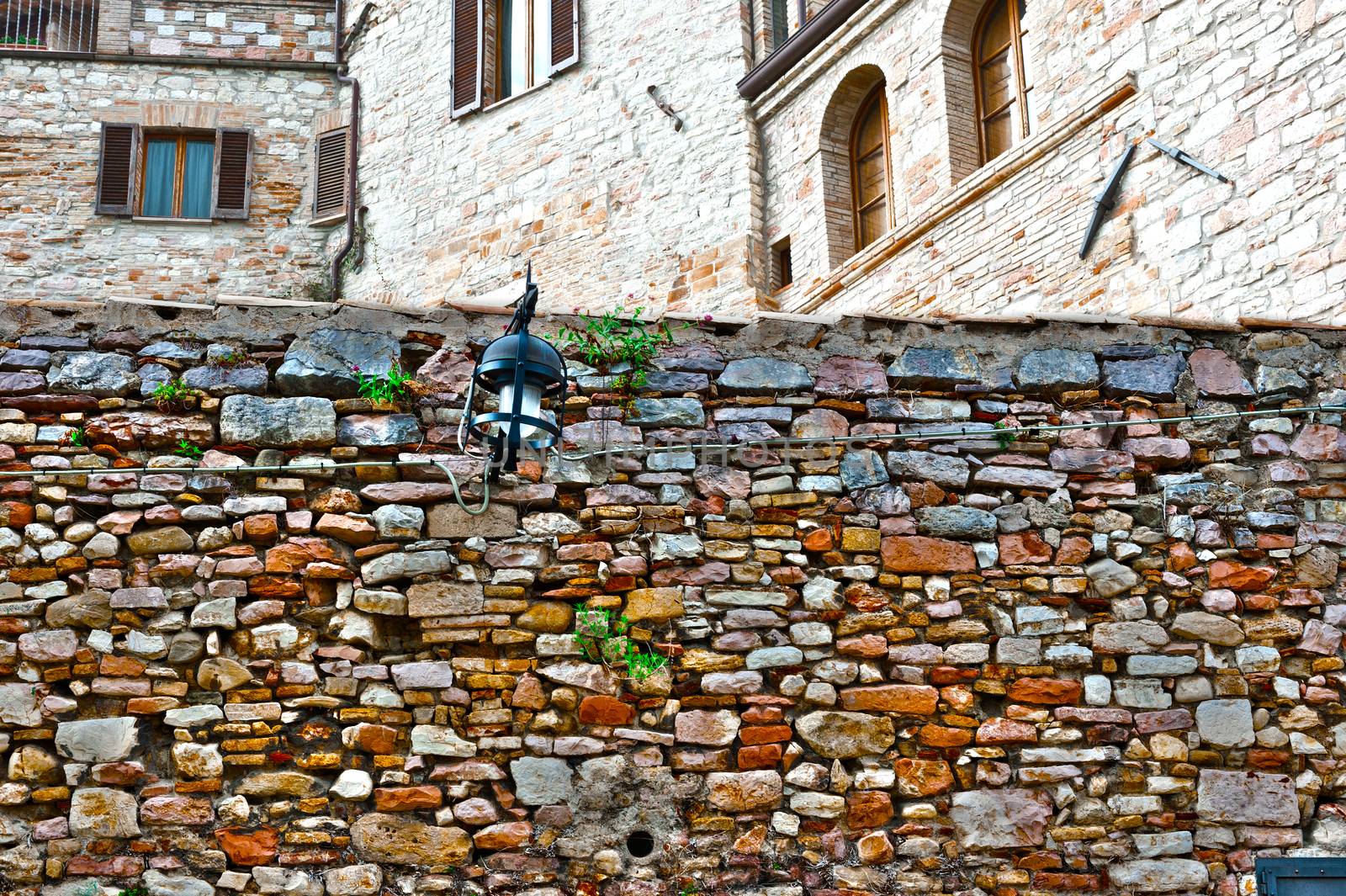 Old Wall on the Background of the Buildings in the Italian Medieval City