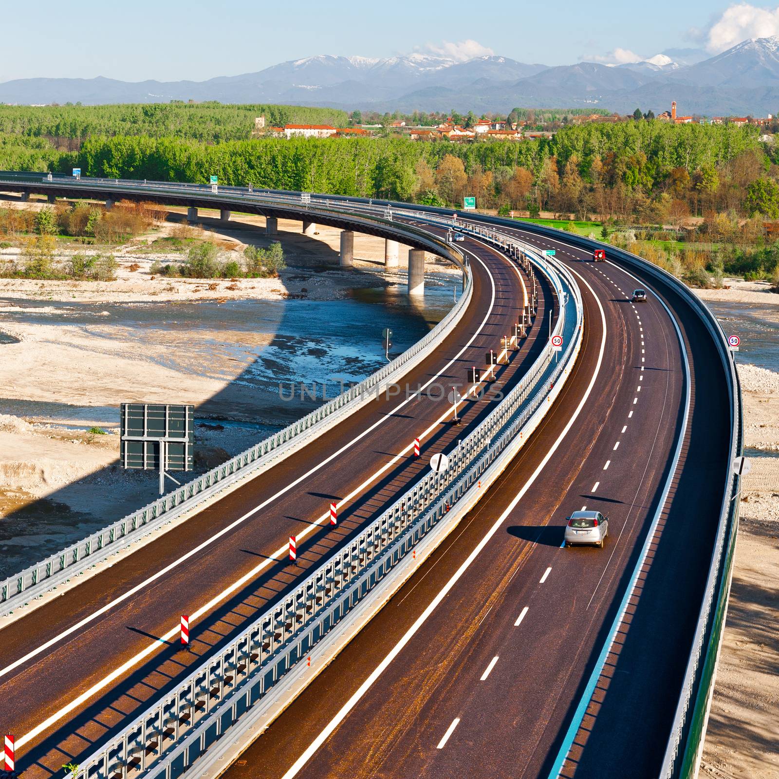 The Modern Highway in Piedmont on the Background of Snow-capped Alps in Italy