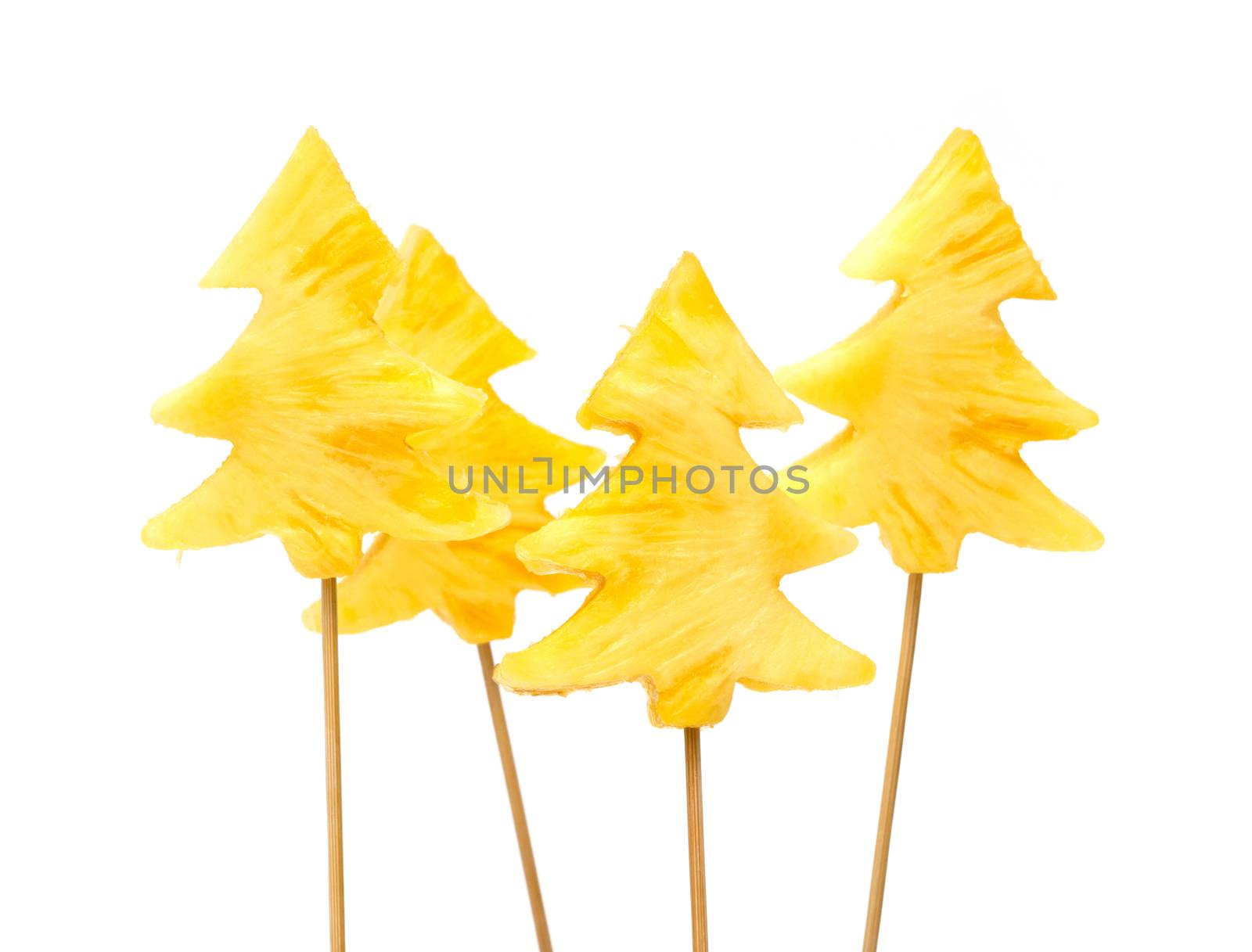 Fresh, raw pineapple chunks nailed on wooden stick isolated over white background