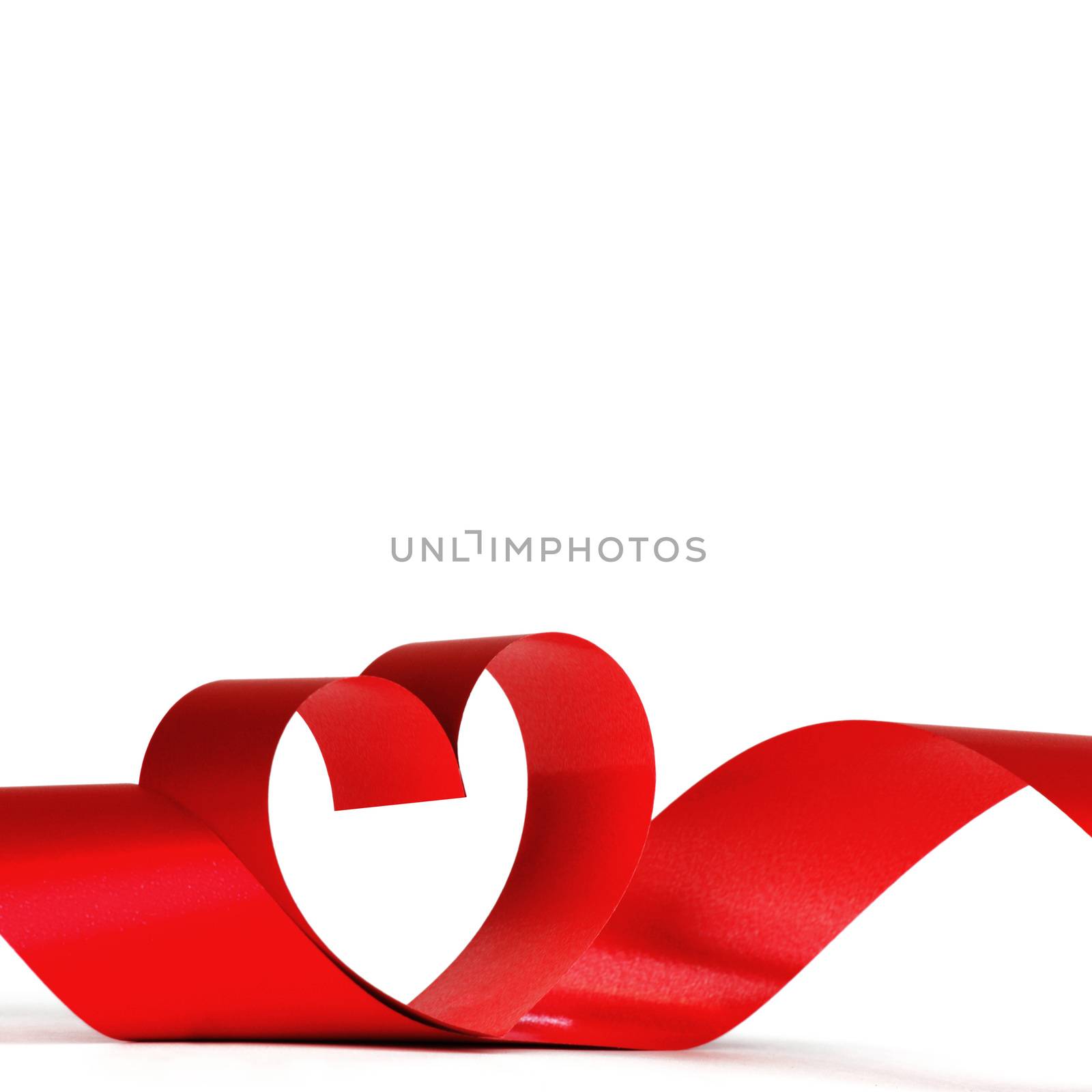 Heart from red ribbon isolated on white background