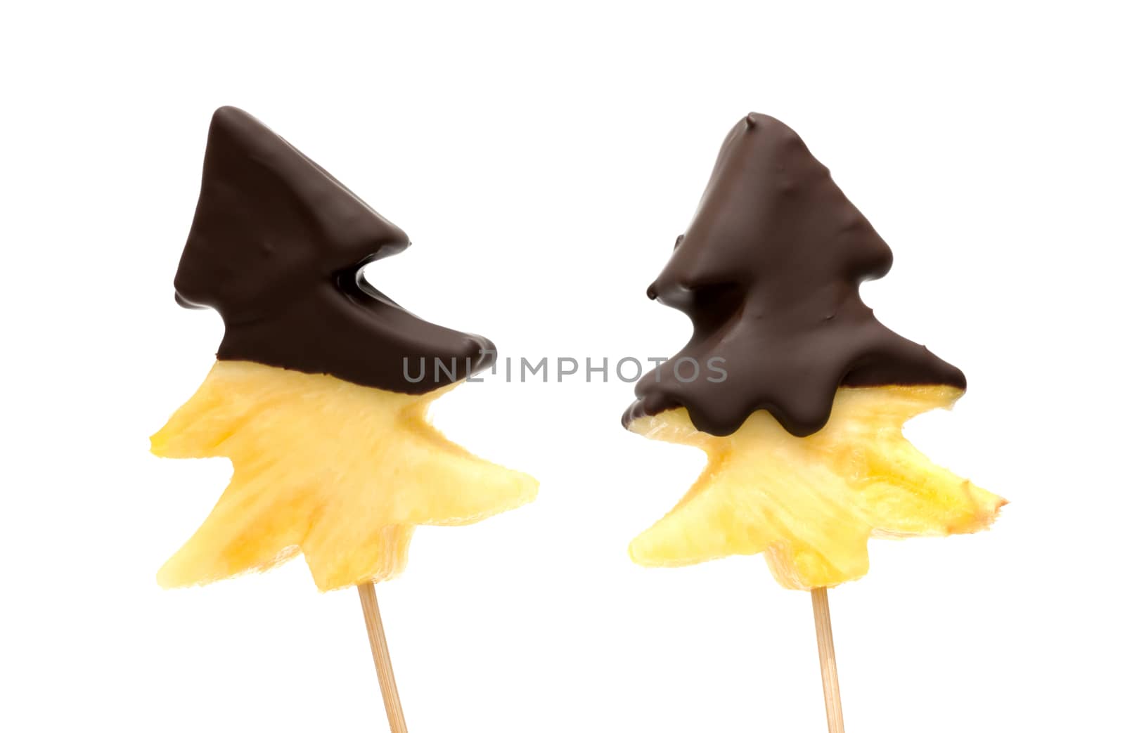 Fresh, raw pineapple chunks nailed on wooden stick isolated over white background