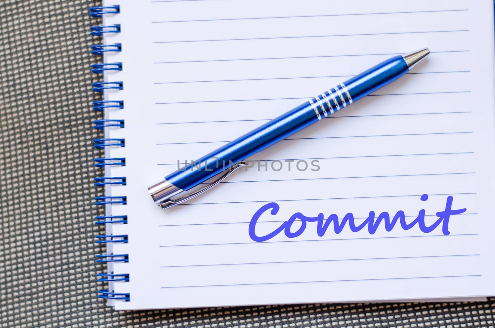 Commit text concept write on notebook with pen