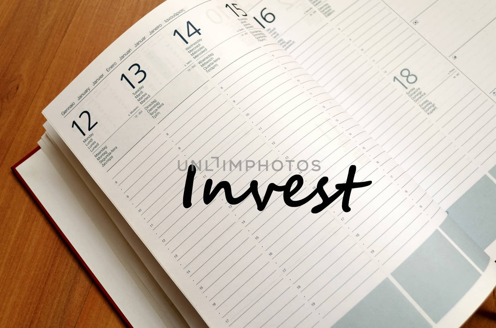 Invest text concept write on notebook with pen