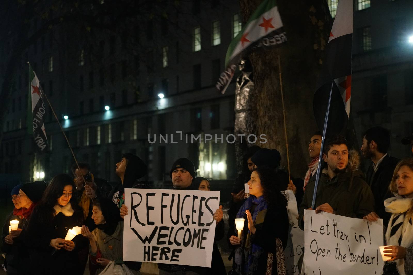 ENGLAND, London: People in support of the refugees gathered in London on December 12, 2015 to hold a Christmas vigil outside Downing Street.The demonstrators held candles and signs calling for refugees to be welcomed.