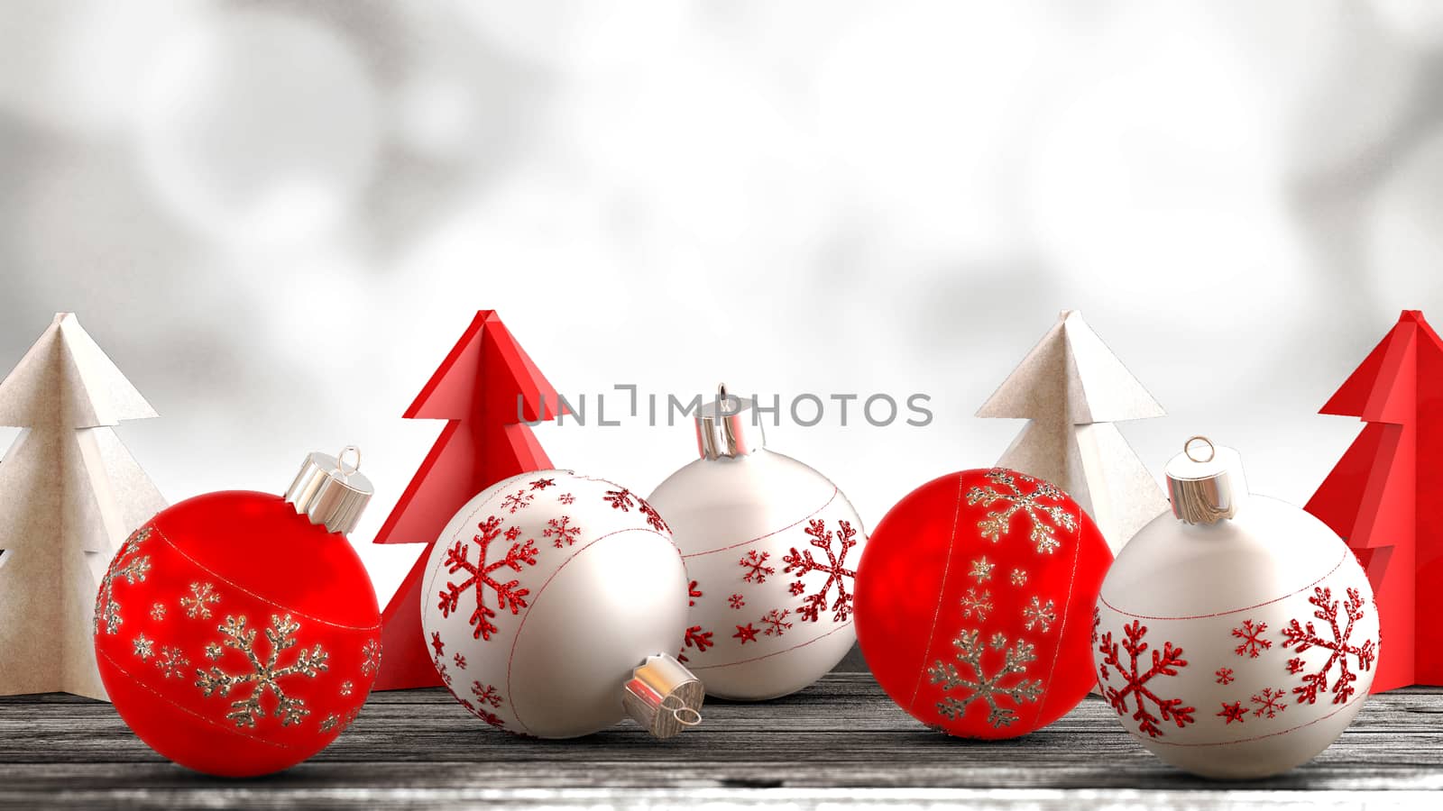 Christmas ornaments, balls, paper trees on a wooden table in front of bokeh background. Copy space available.