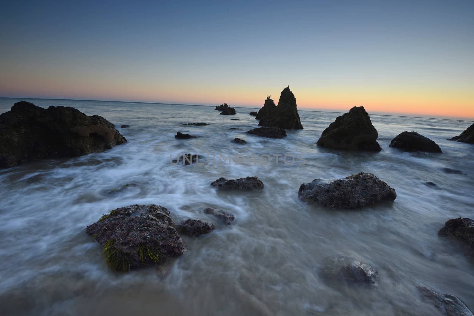 rock sea stack at a beach near malibu