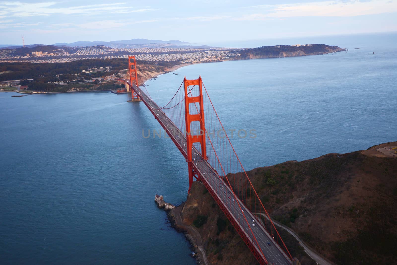 an aerial view of golden gate bridge in san francisco during sunset, taken from a helicopter