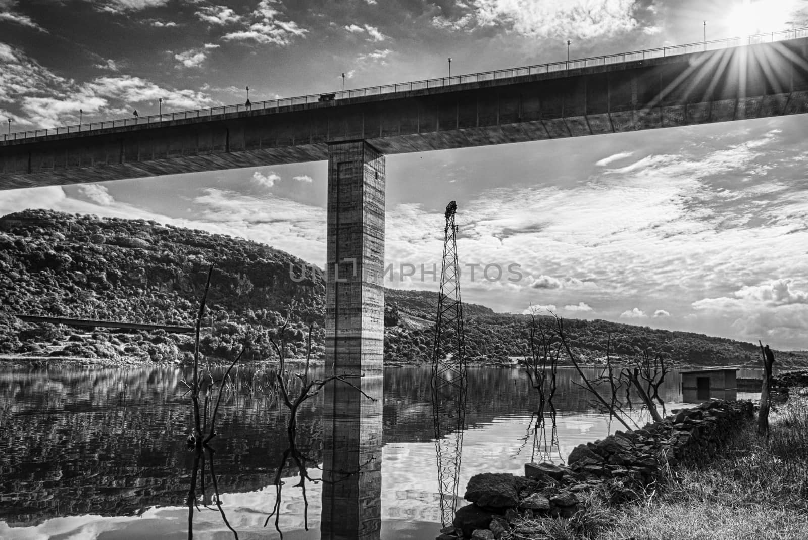 The dam on the lake omodeo in a sunny afternoon, Sardinia, in black and white