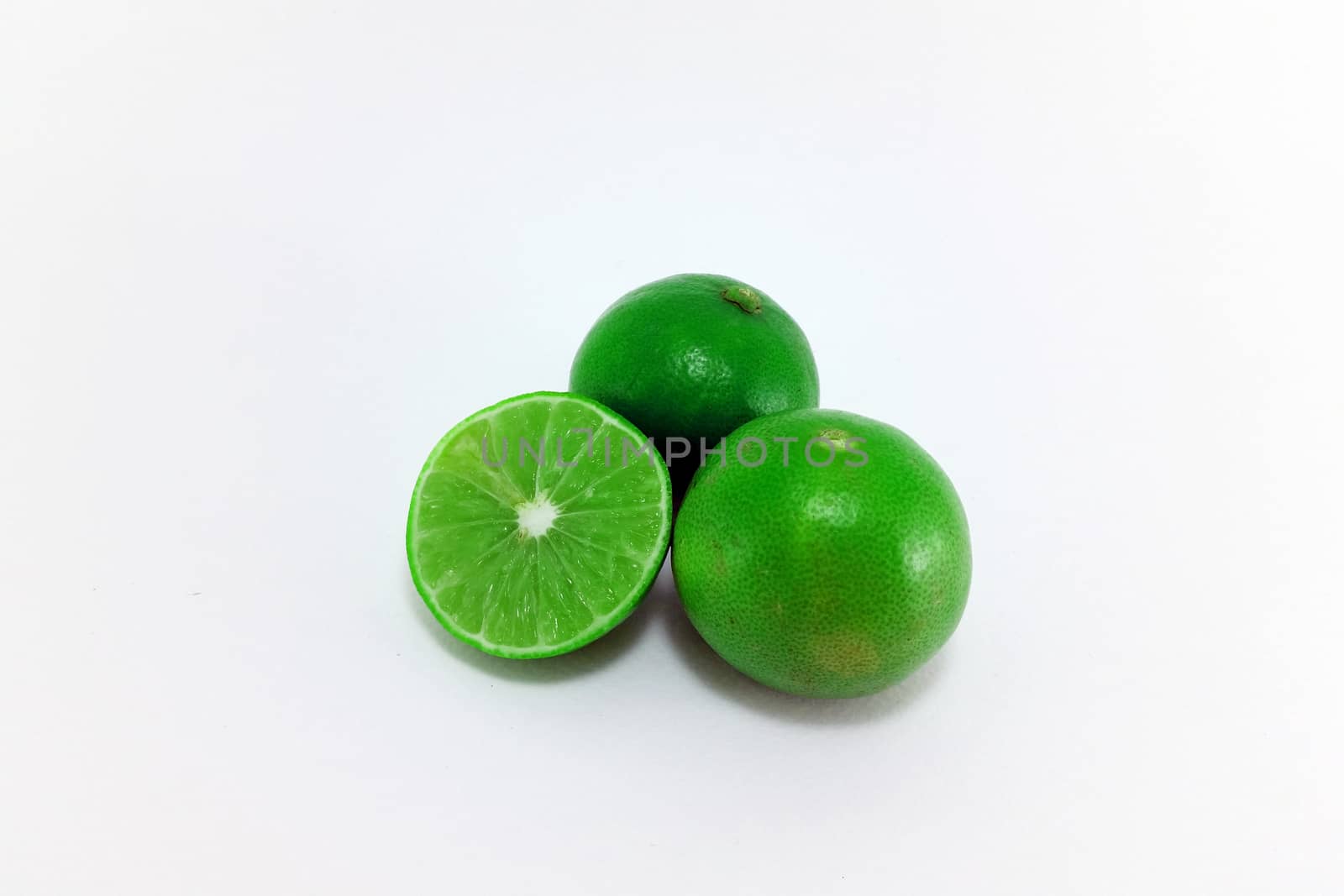 a group of 2 and a half limes on white background