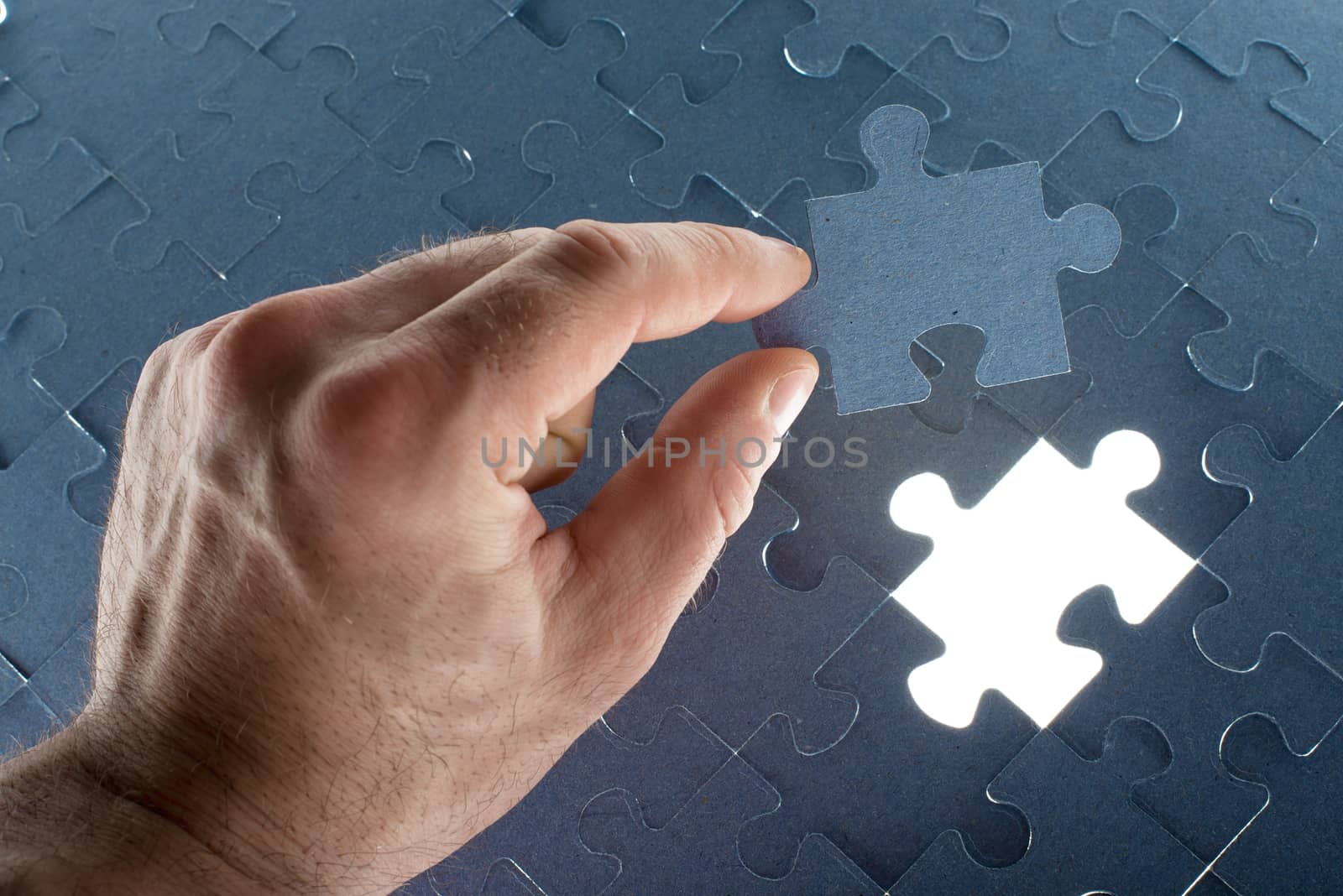 Missing jigsaw puzzle piece with light glow by cherezoff