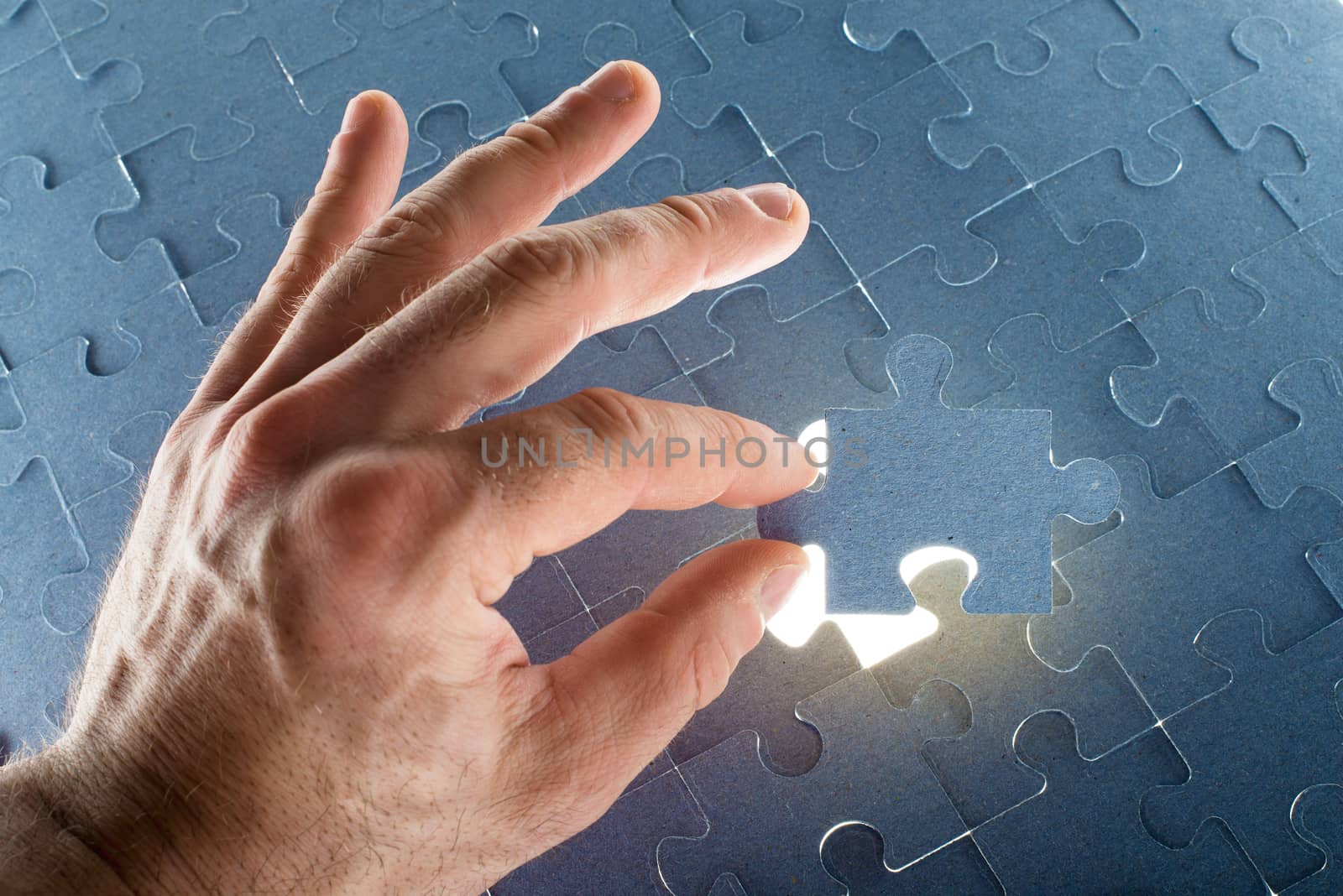 Missing jigsaw puzzle piece with light glow by cherezoff