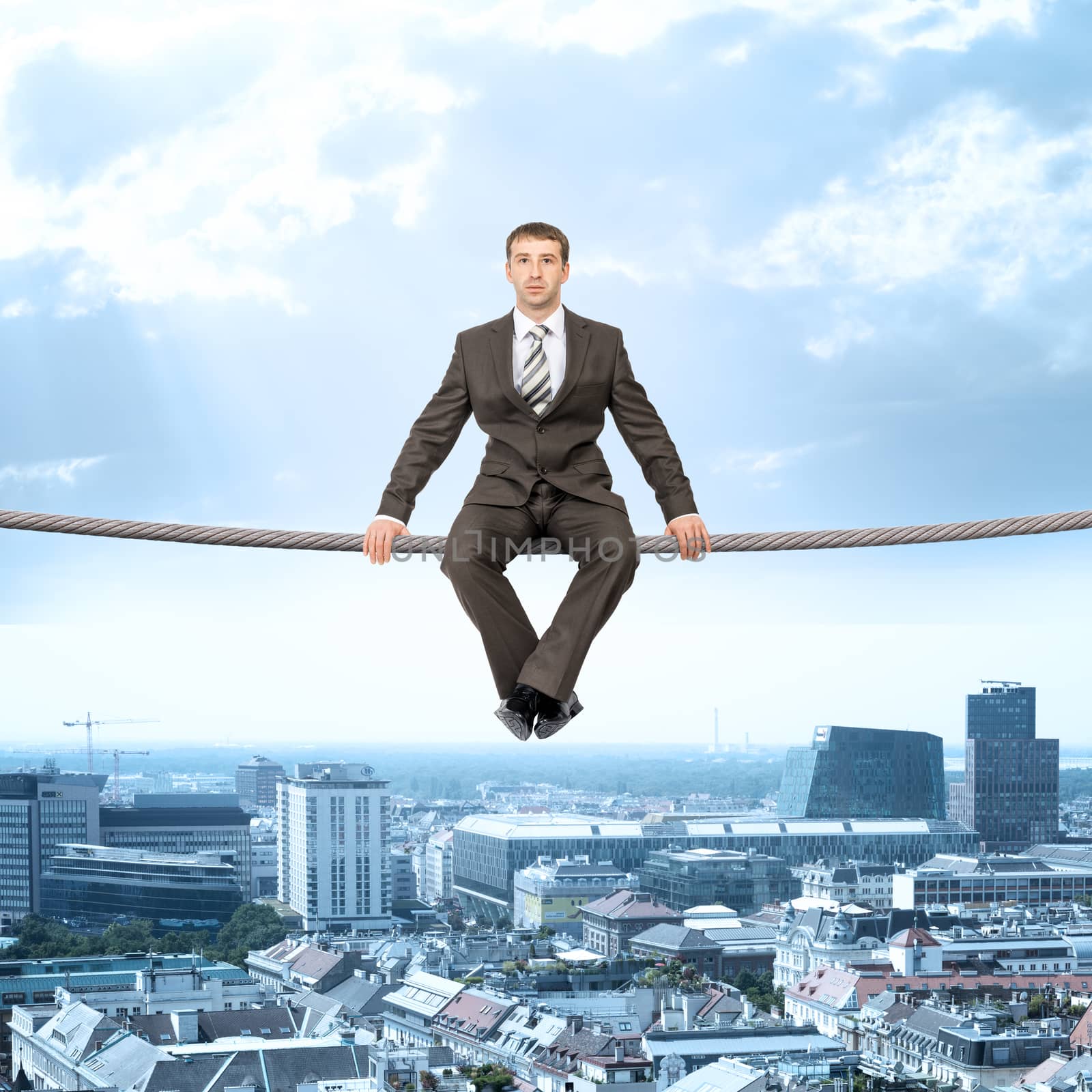 Businessman sitting on rope by cherezoff