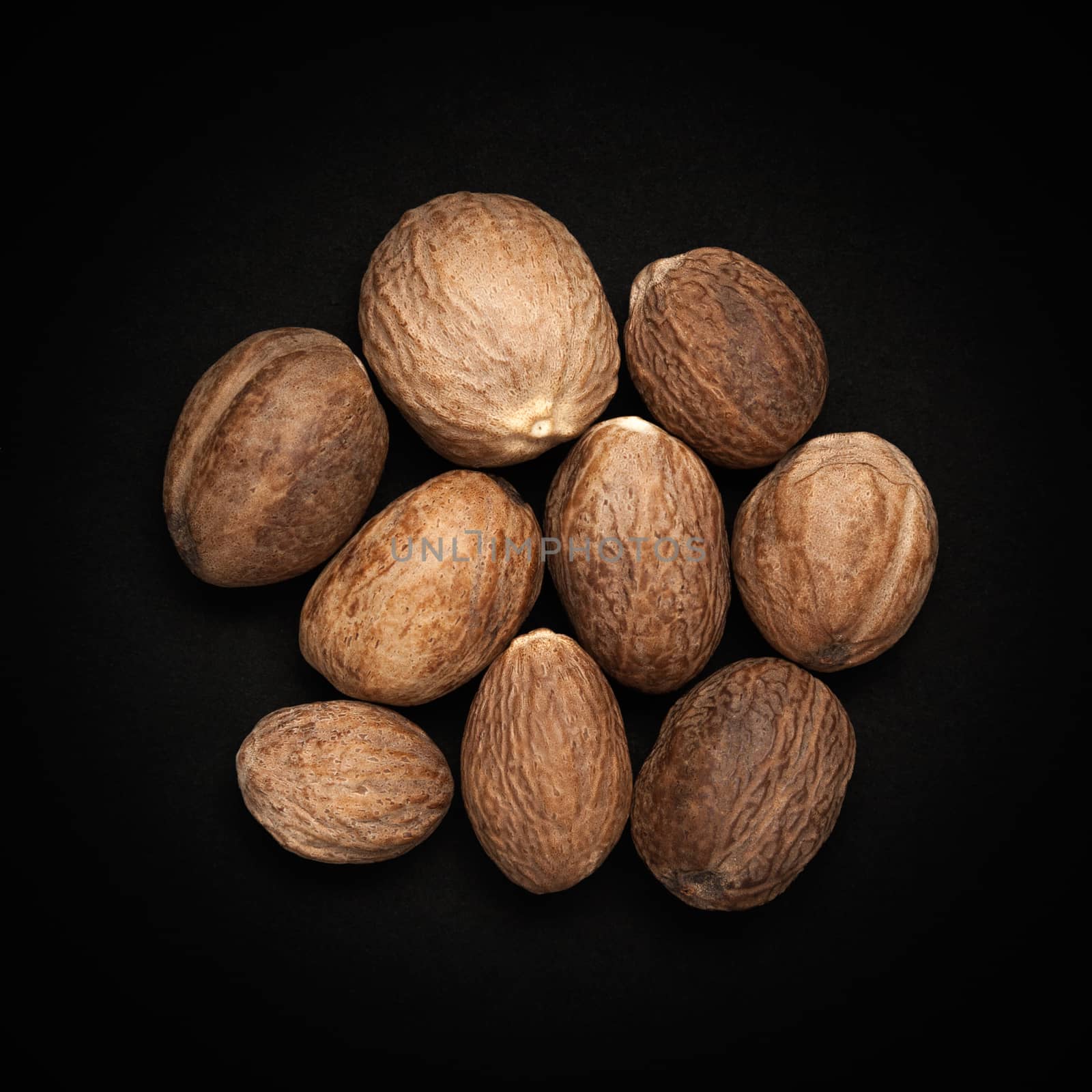 Top view of Organic Nutmeg Seed or Jaiphal (Myristica fragrans) isolated on dark background.