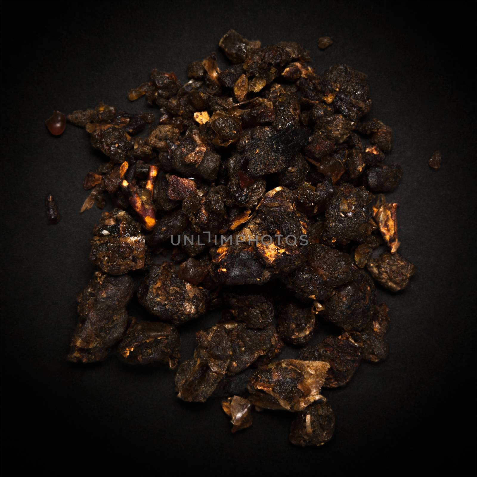 Top view of Organic Indian bdellium or Guggul resin (Commiphora wightii) isolated on dark background.