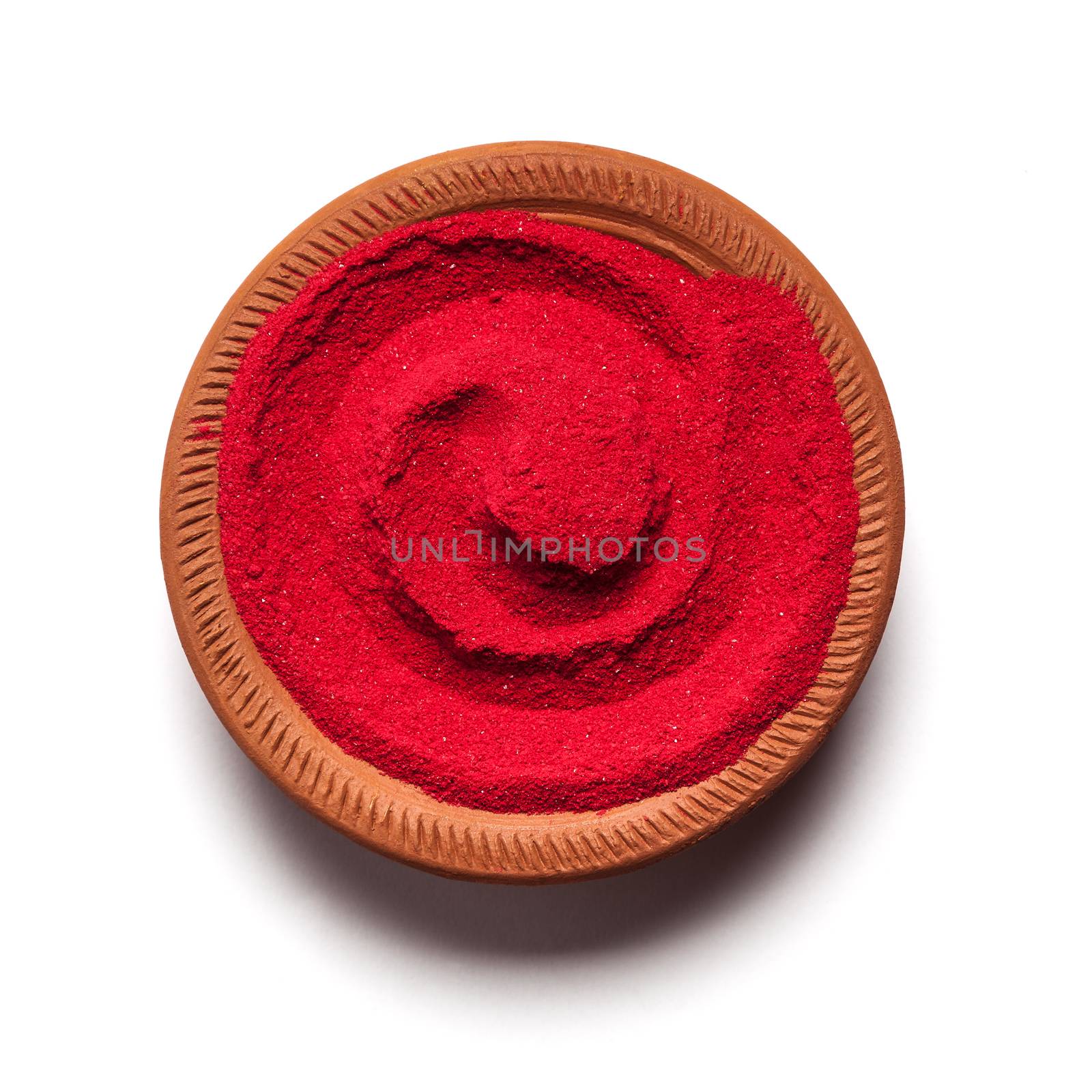 Top view close up of red color made of soil in clay pot on white background.