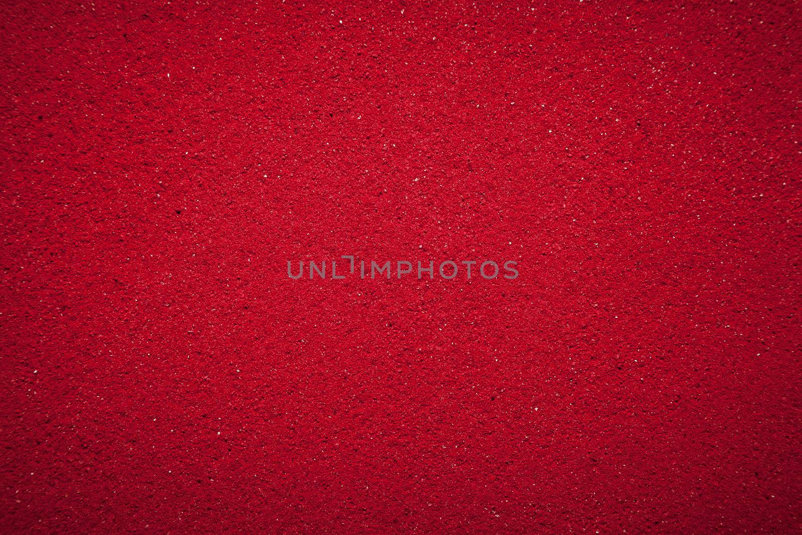 Background texture of solid red color made of soil.