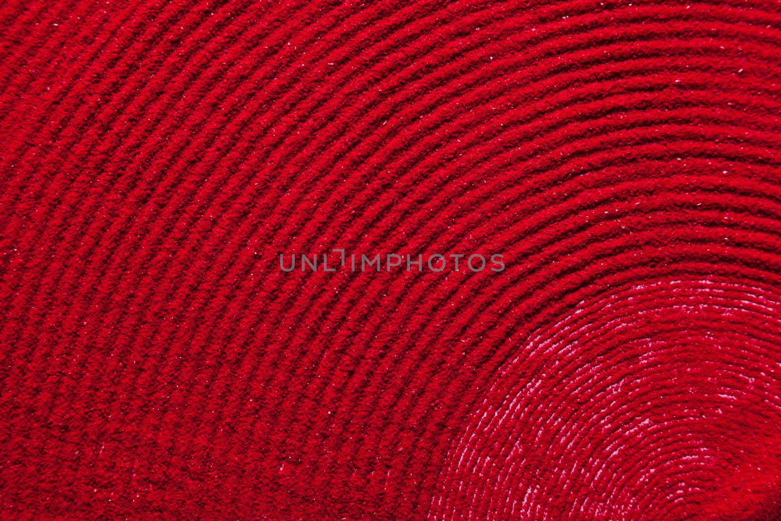 Close up spiral background texture of solid red color made of soil.