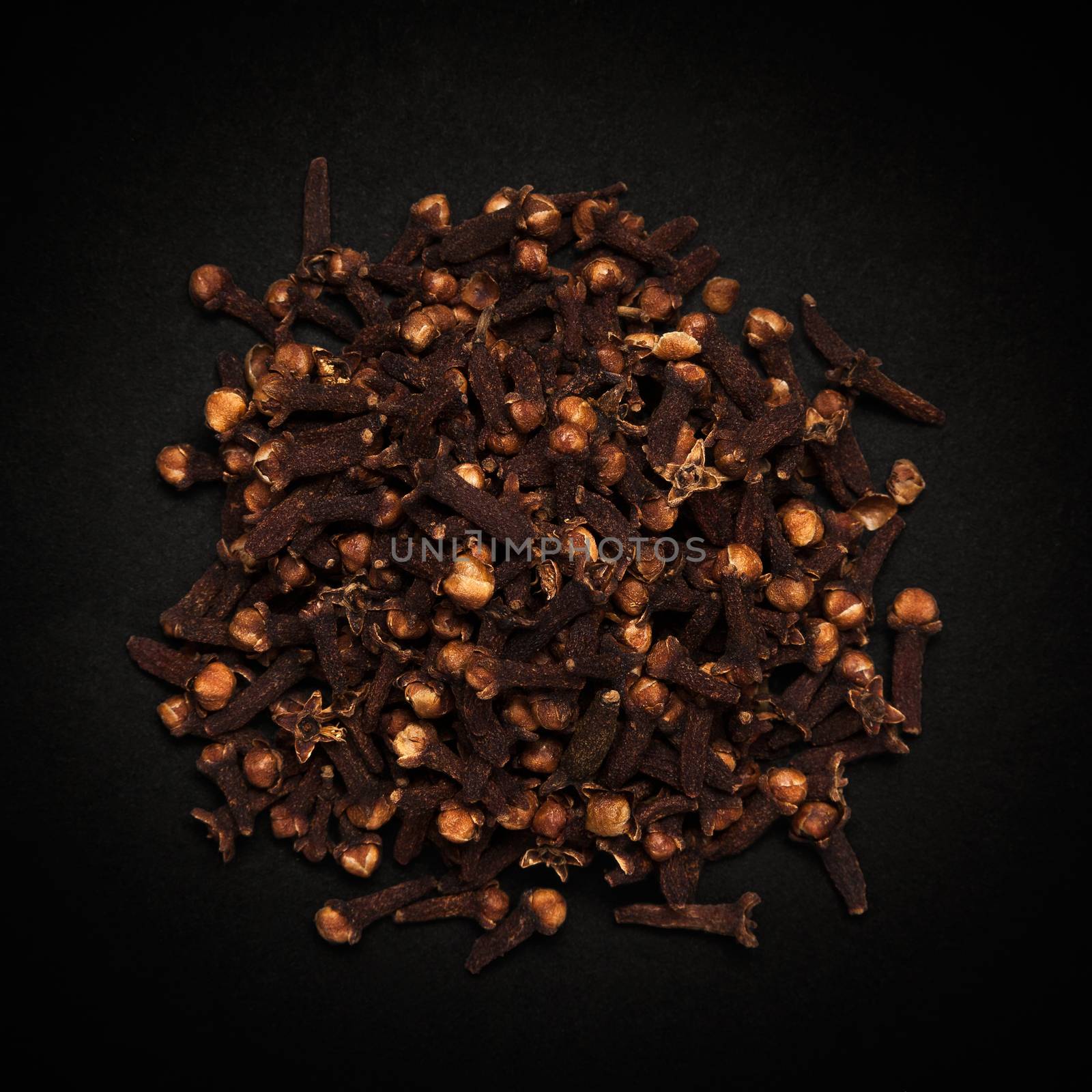 Top view of Organic black clove (Syzygium aromaticum) isolated on dark background.