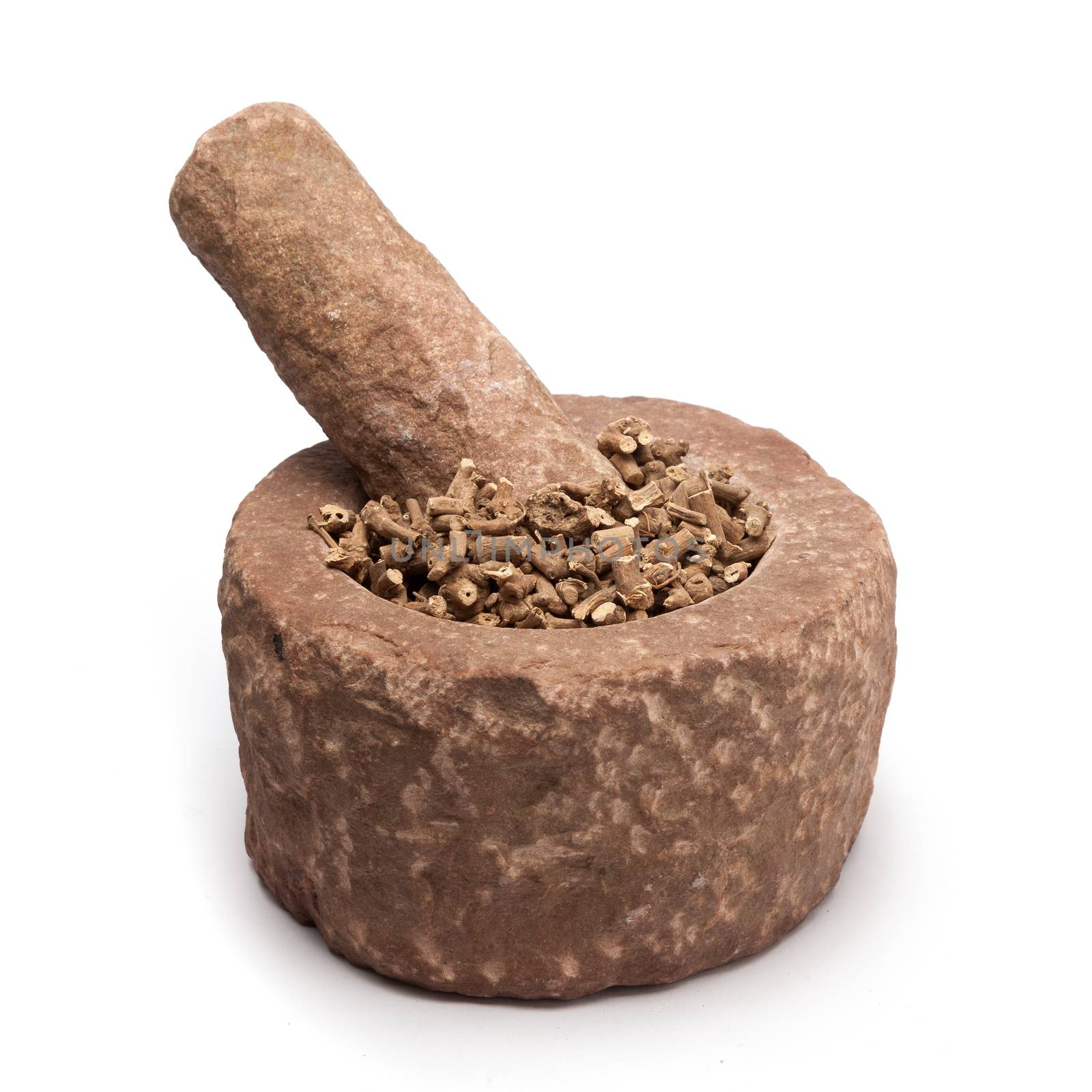 Organic Ganthoda or Long pepper Roots (Piper longum) in mortar with pestle, isolated on white background.